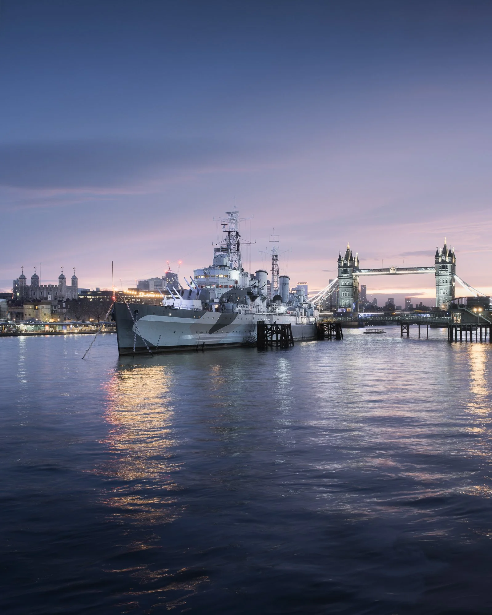 London cityscape at sunrise featuring HMS Belfast and Tower Bridge