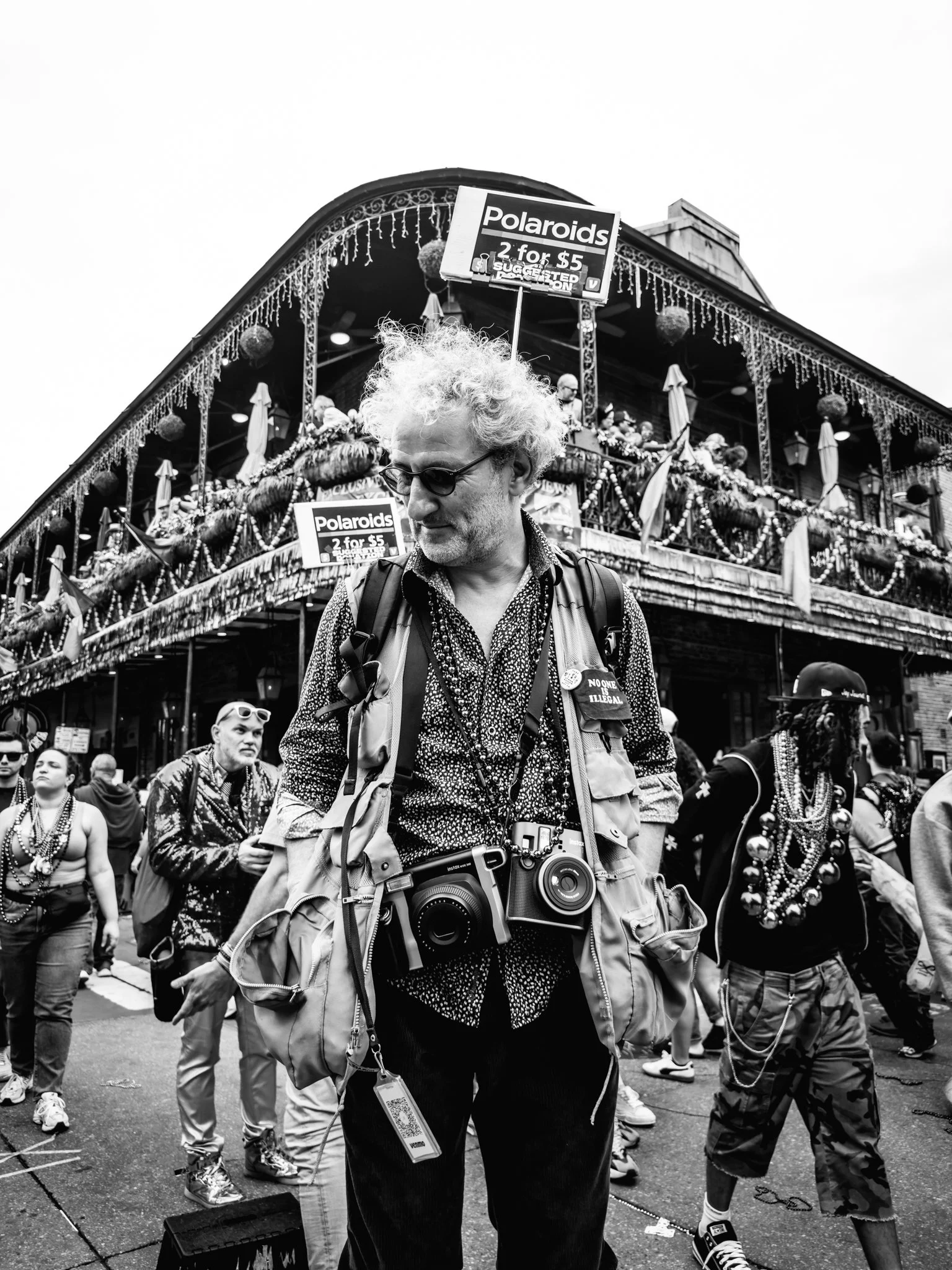 Bourbon Street vendor sells polaroids to tourists on Mardi Gras day.