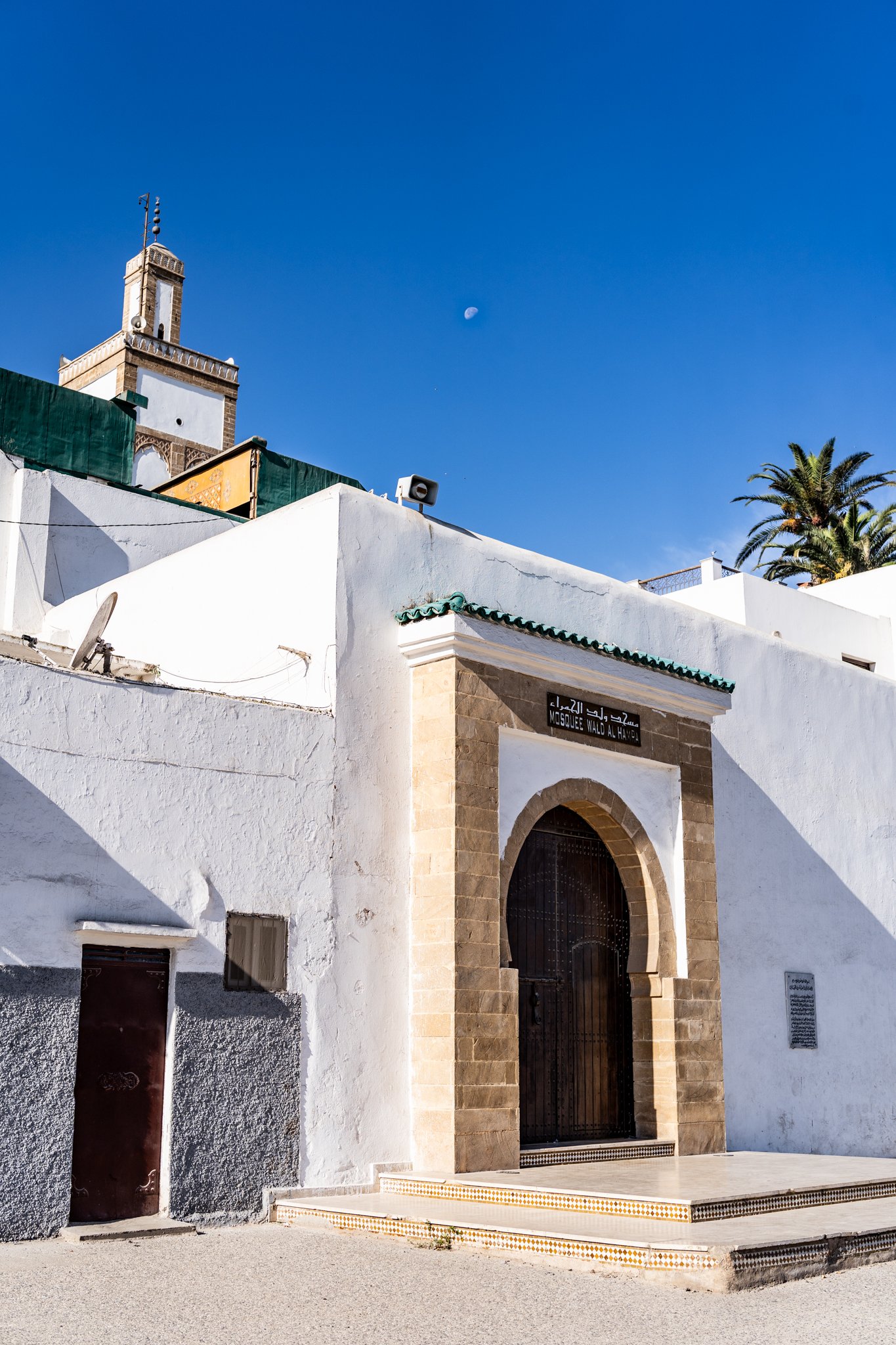The Moon is visible above a kasbah in Morocco.