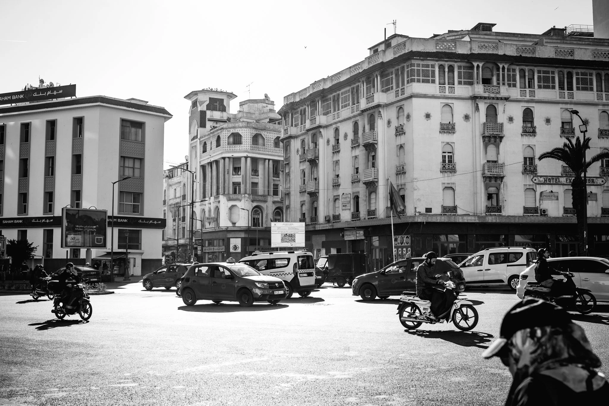 The streets of the city of Morocco where cars and people intersect.