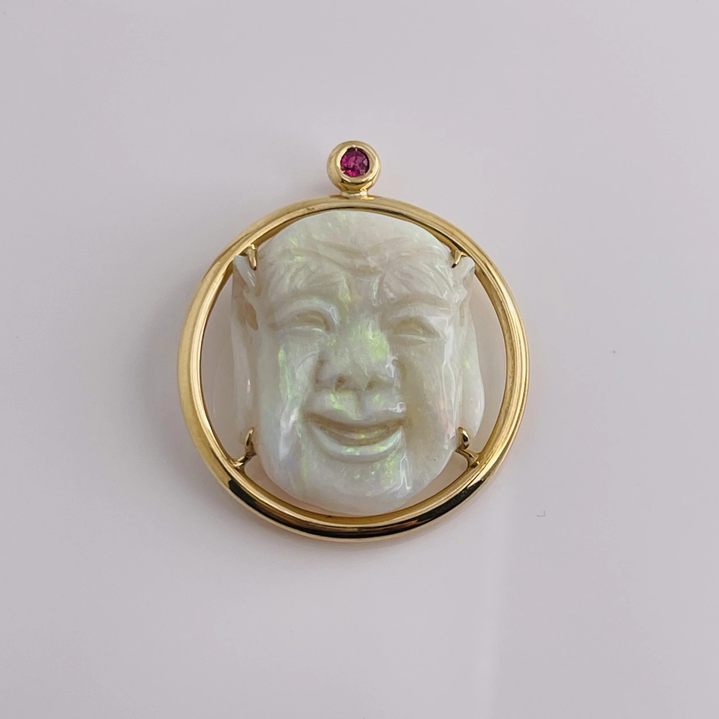 14 Karat Yellow Gold Opal carving pendant with Ruby