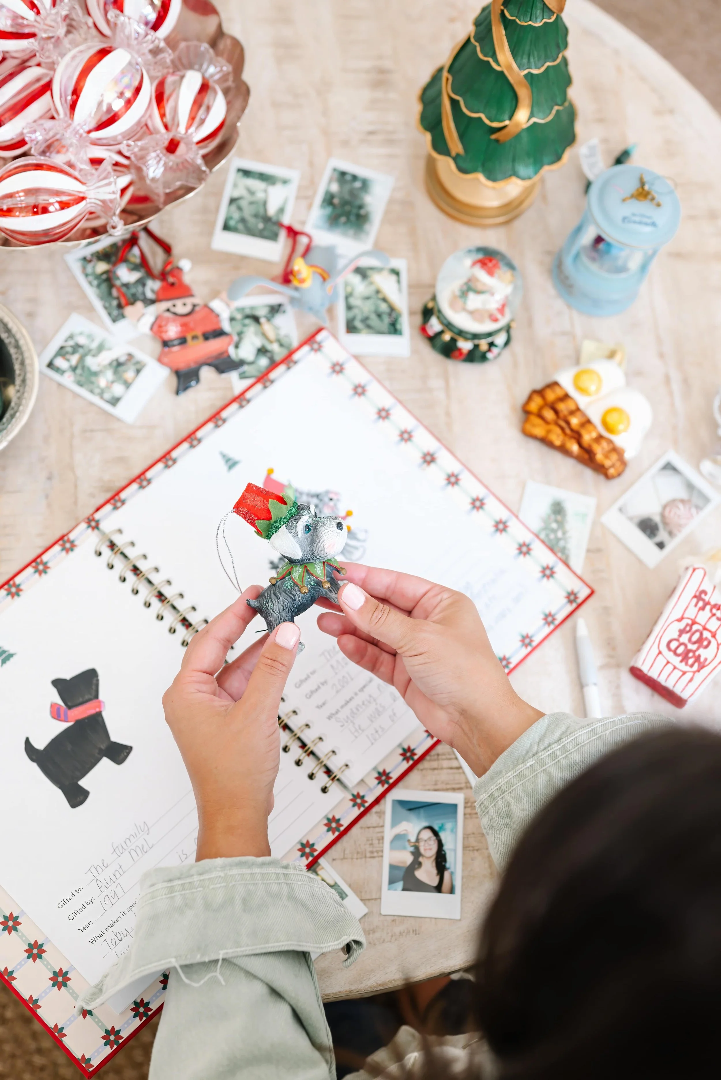 Annie Bradshaw drawing her dog’s Christmas ornament in the Christmas ornament book.