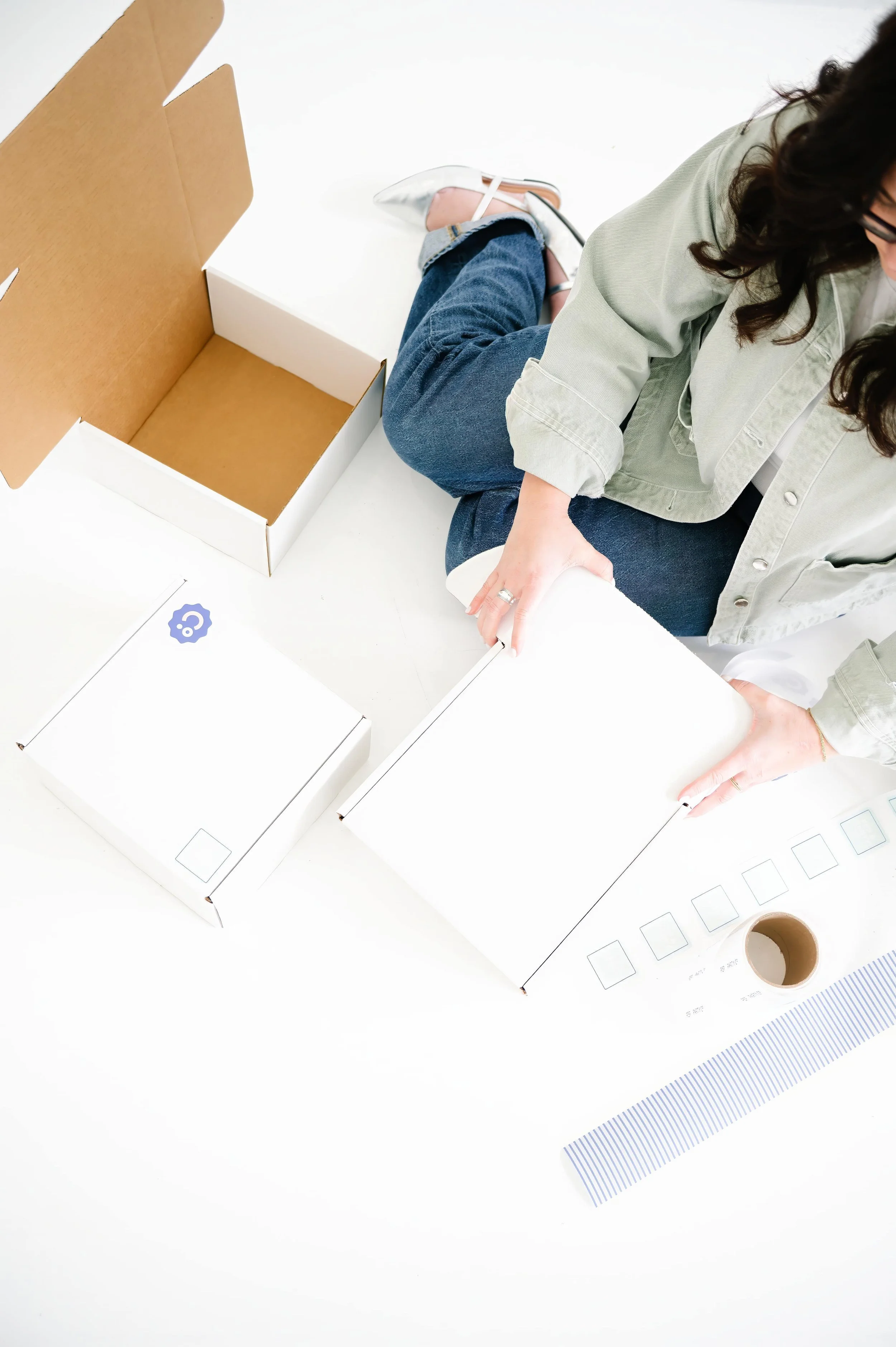 Annie Bradshaw packaging custom gift boxes for personalized gifting experiences.