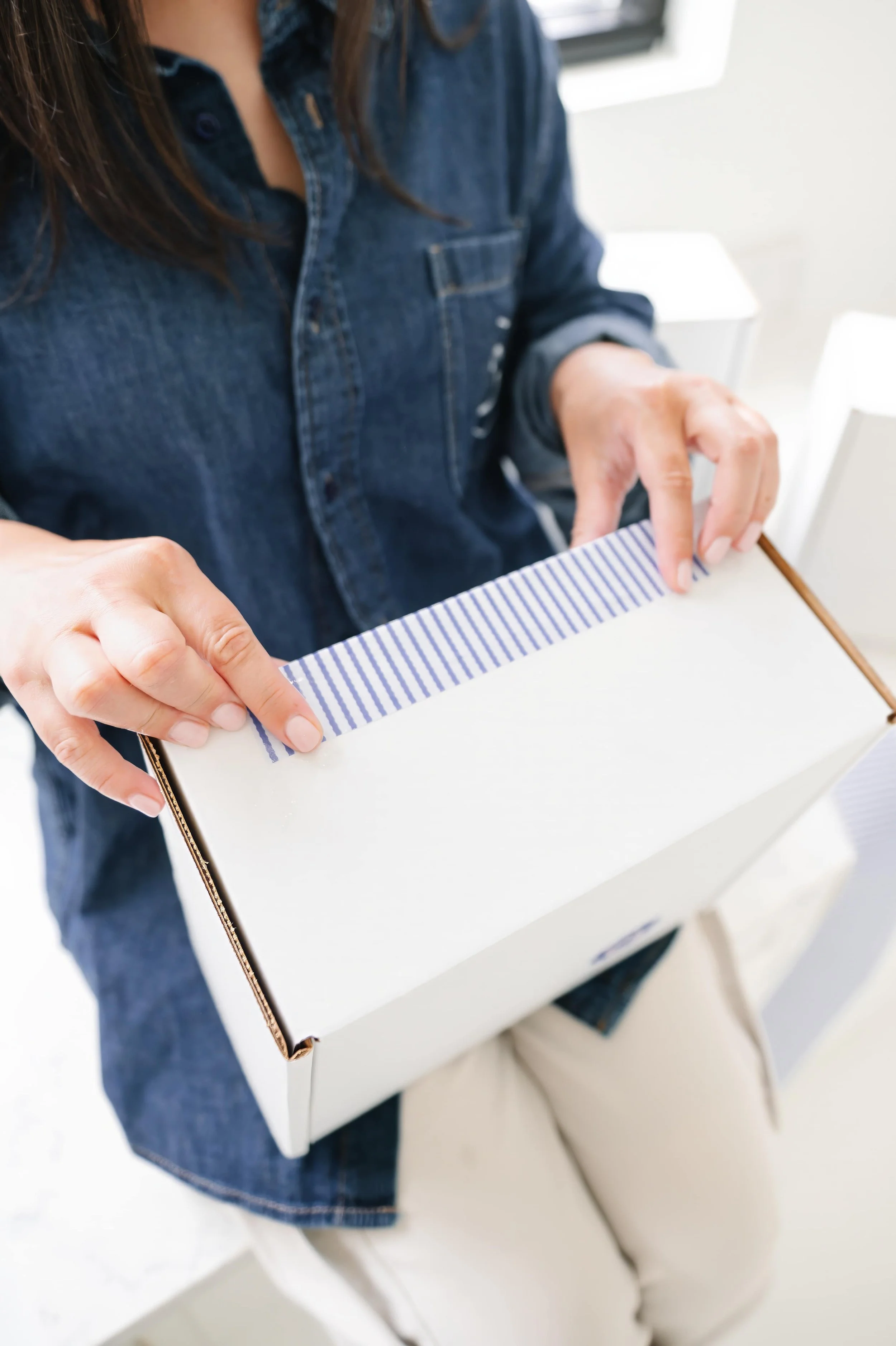 Annie Bradshaw wrapping a custom gift box for a personalized gifting experience.