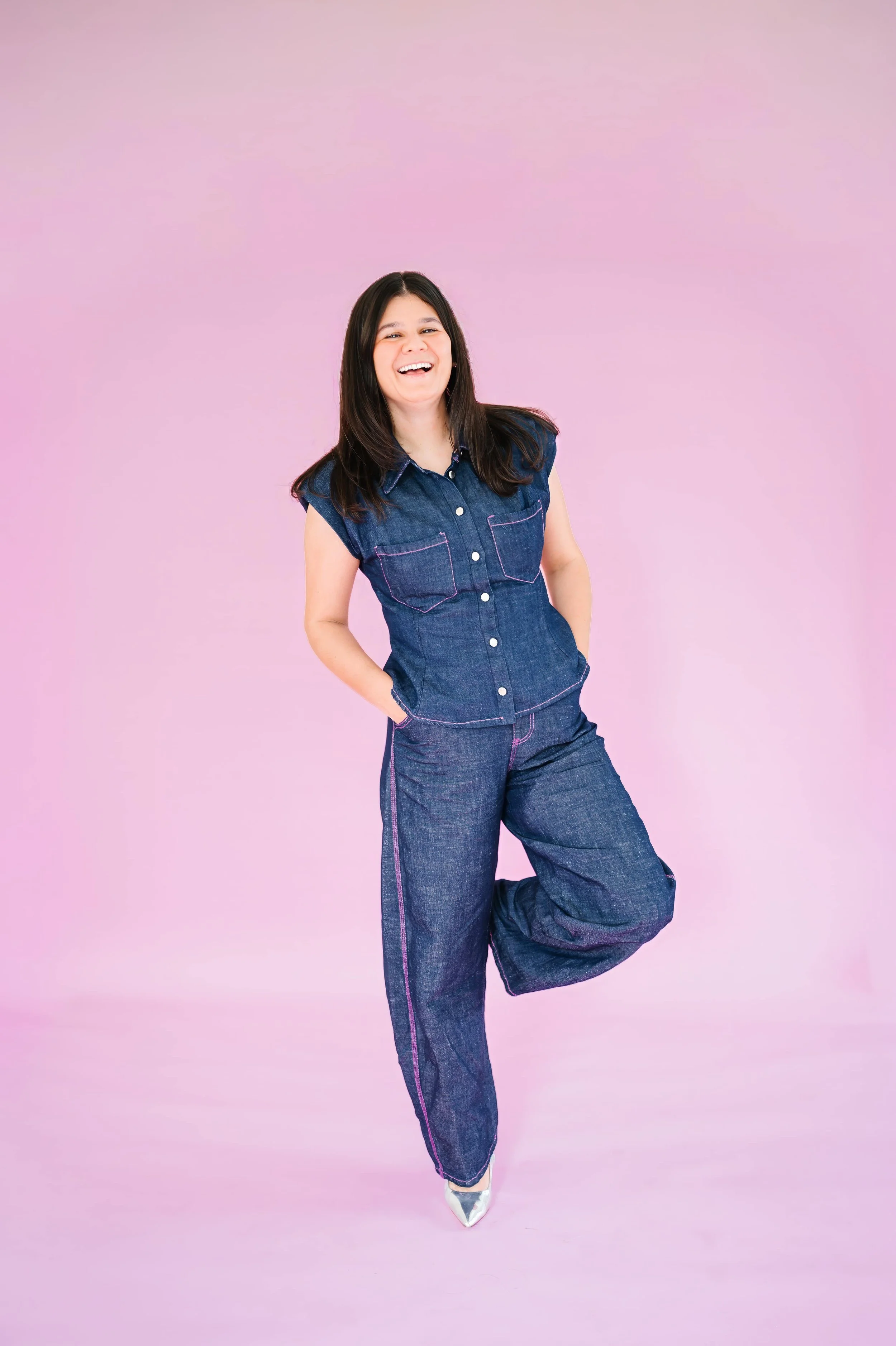Annie Bradshaw standing on a pink background as the founder of Pep & Party Co., creating thoughtful custom gift experiences.