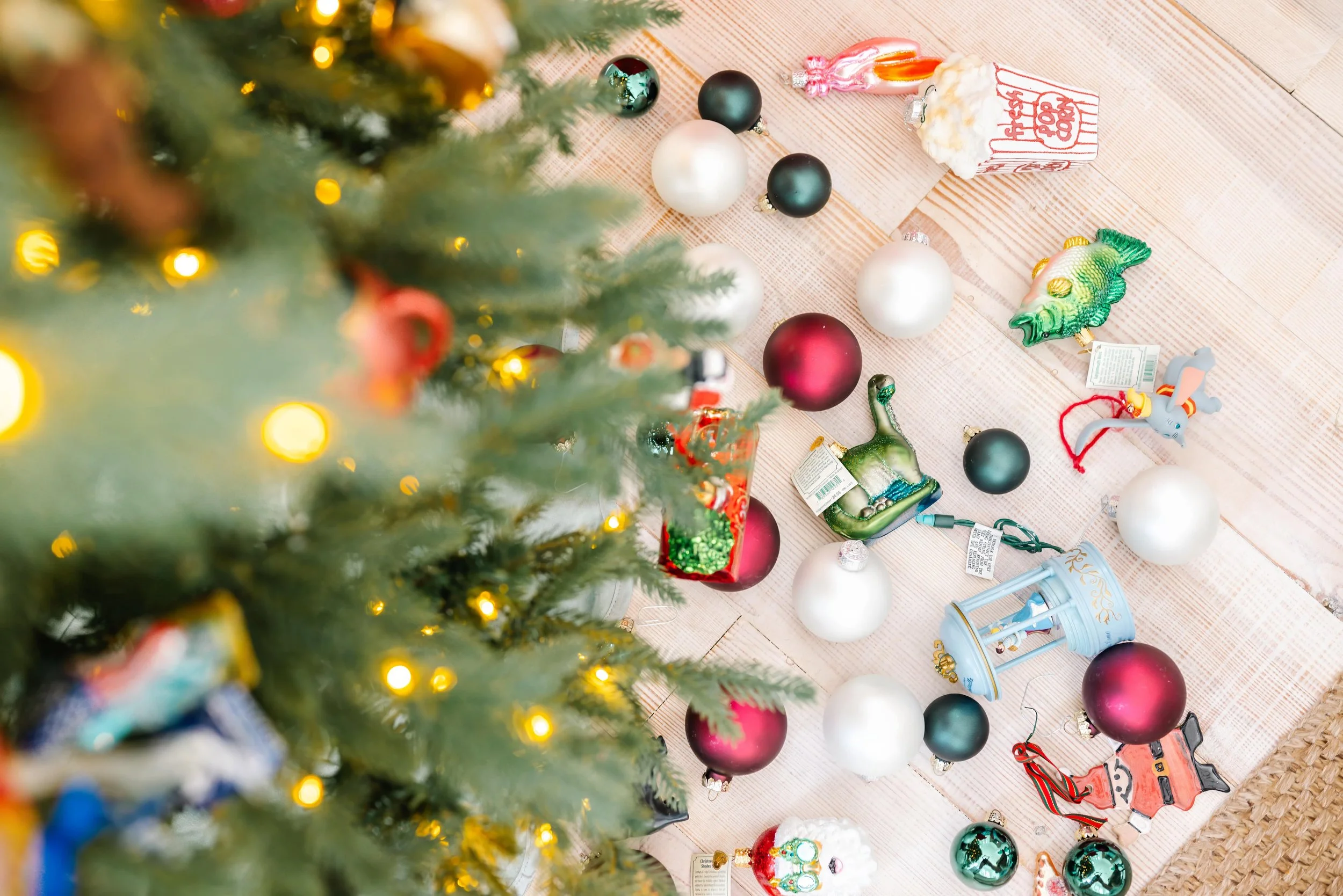 Christmas ornaments scattered underneath the Christmas tree.
