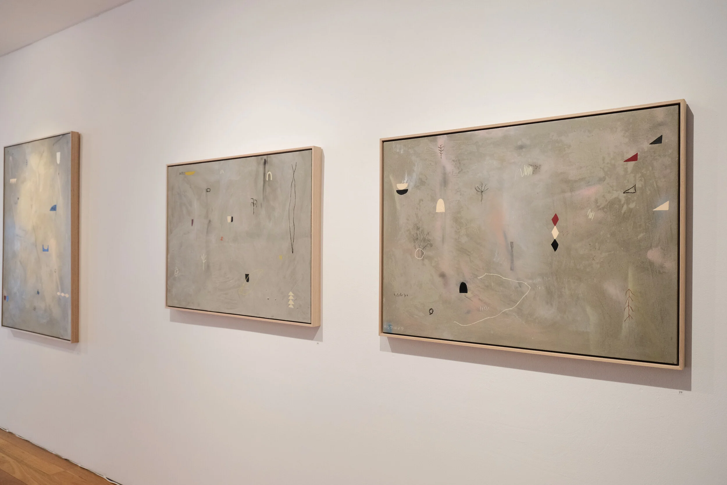 Abstract paintings hanging on a white gallery wall