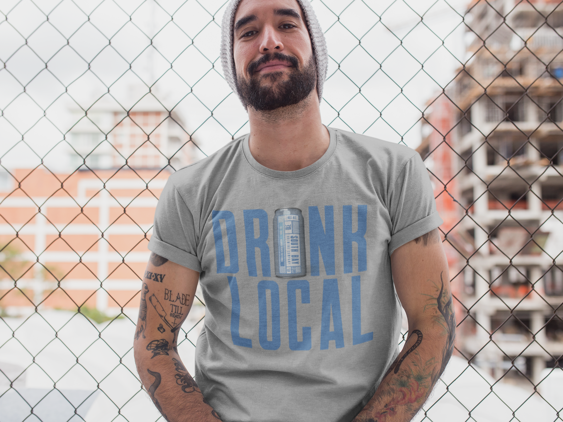 hipster-middle-aged-man-wearing-a-round-neck-tee-mockup-while-lying-against-a-fence-a17020.png