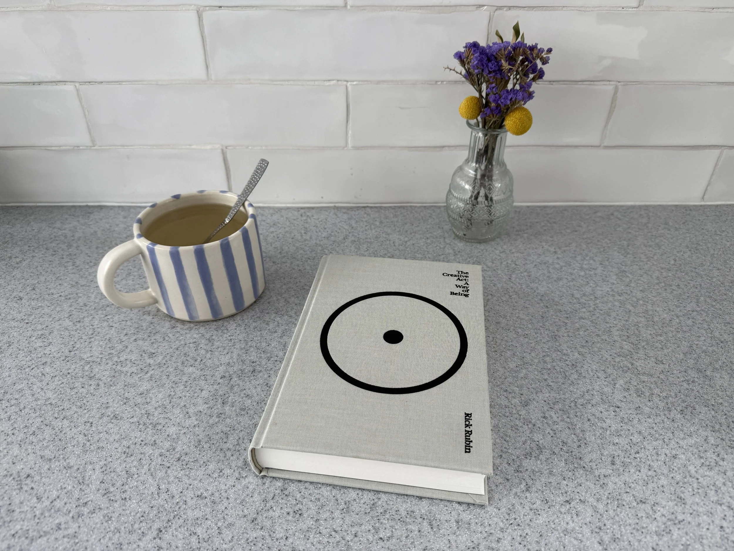 the creative act a way of being book beside a mug of coffee creative impact sector mission driven creativity