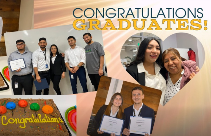 Group of graduates holding diplomas at a graduation celebration, with a cake that says "Congratulations" and a large sign that reads "Congratulations Graduates!" in the background.