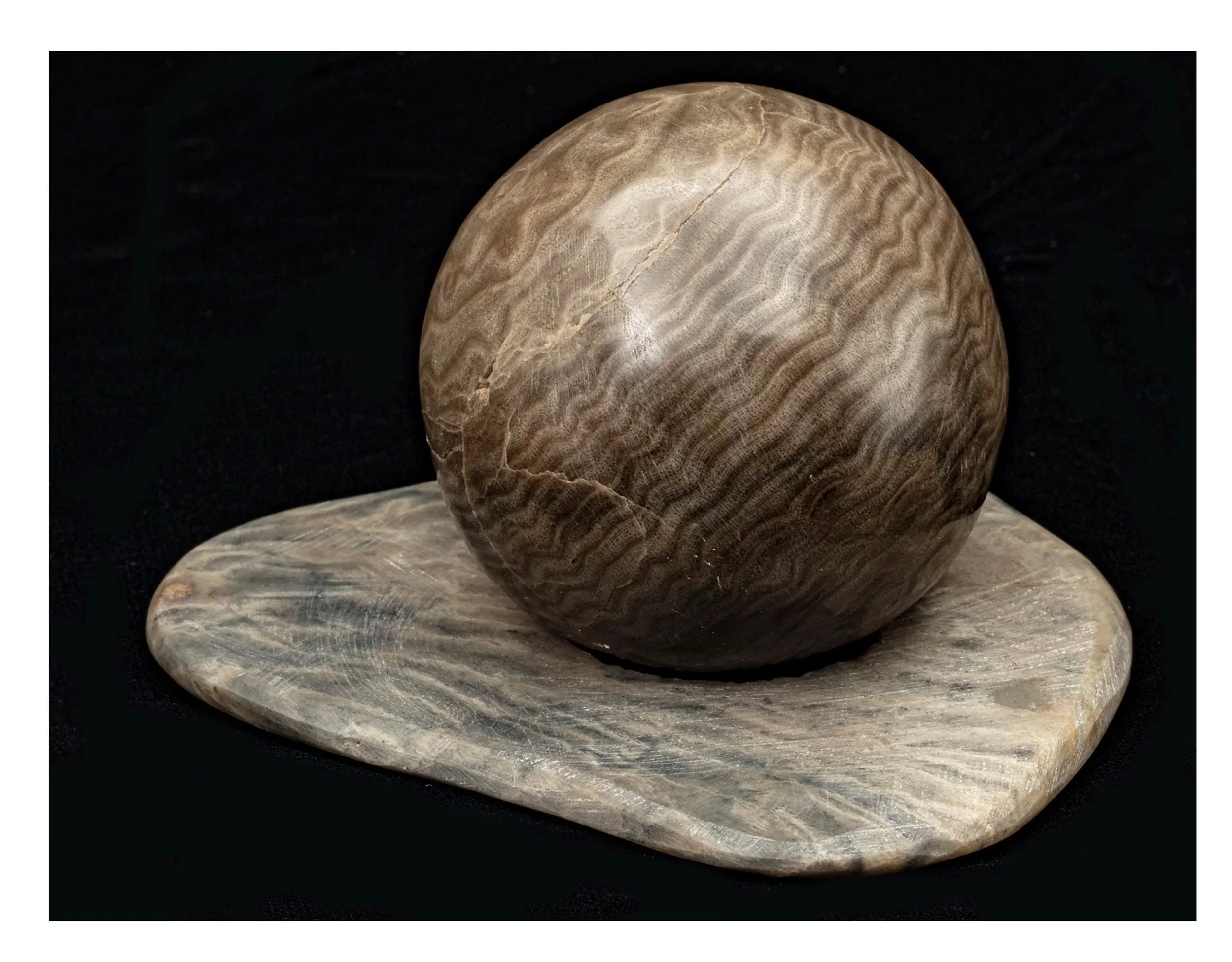 This sphere and it's base are made of Stromatoporoid,  a fossilized sea sponge from 350 million years ago