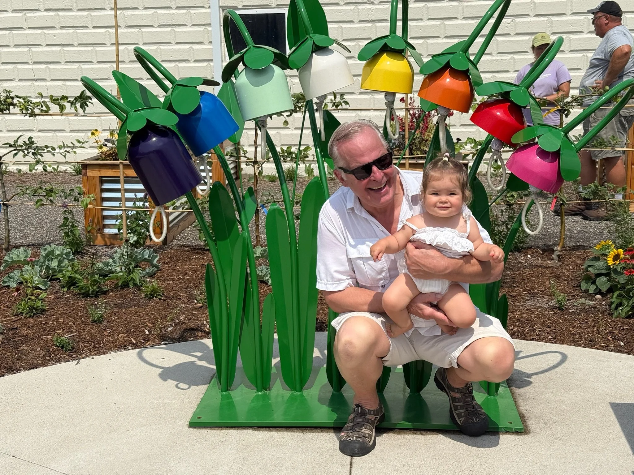 With my grand daughter, in front of a Kinderbells installation. There are eight notes.