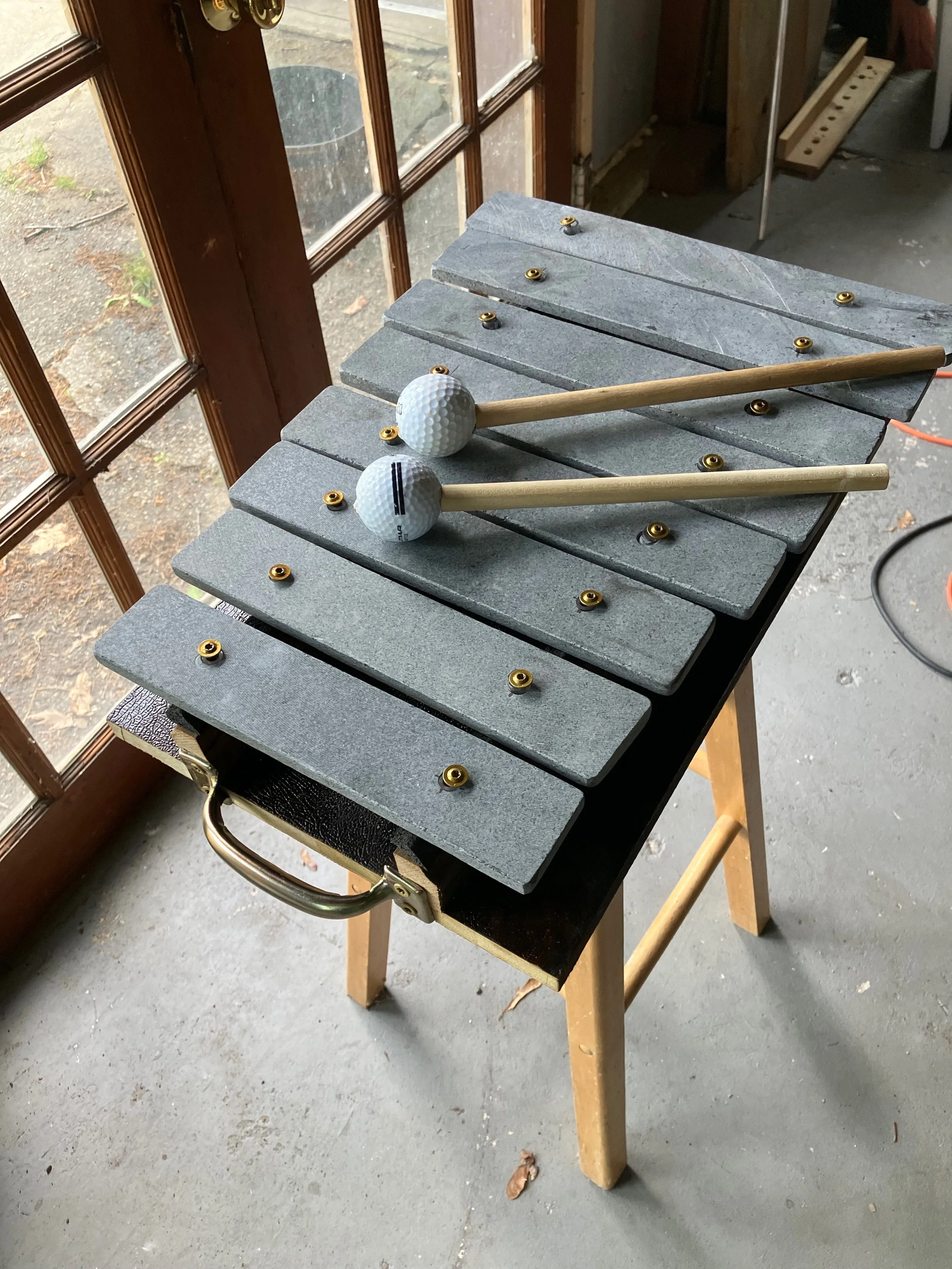 A small portable lithophone,  made for the traveling exhibits of Raven Hill Discovery Center