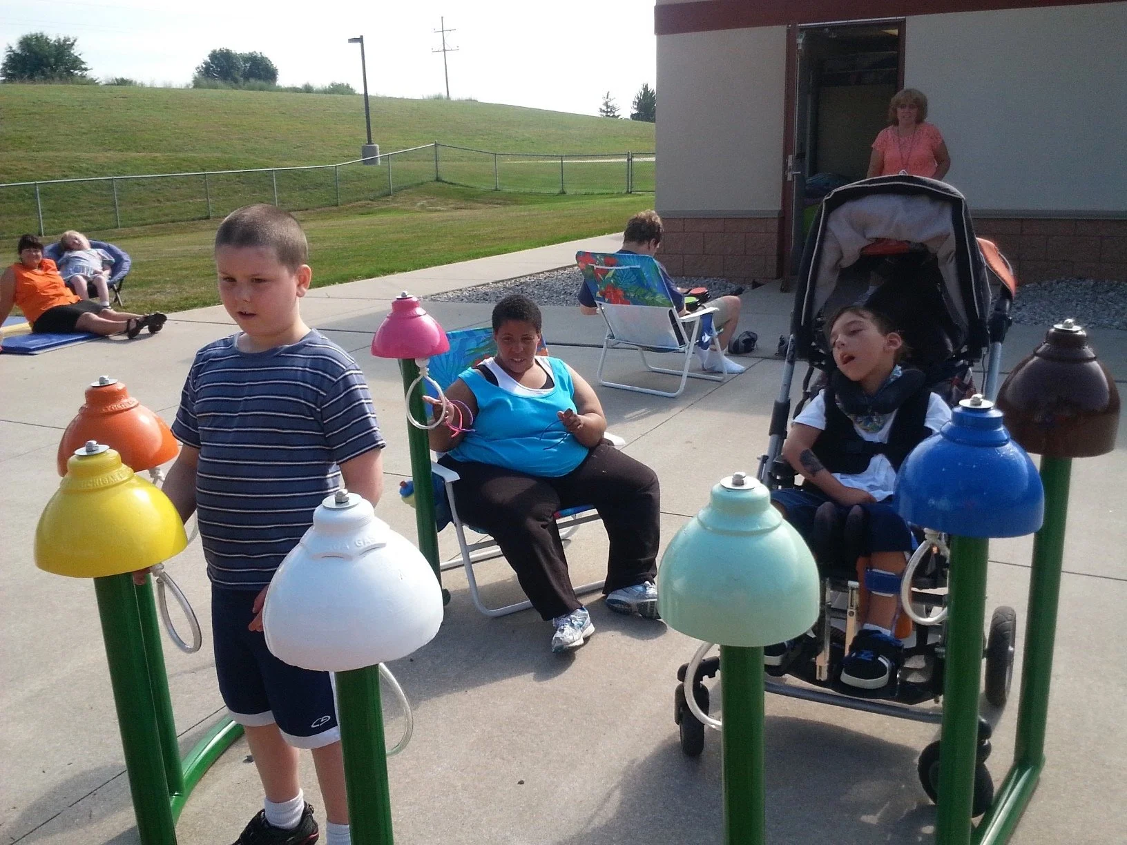 Students at Taylor School using the first set of clappers made from golf balls,  which were added to the bells shortly after installation.