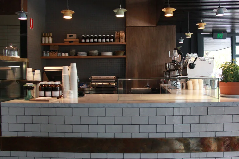 Feature pendant lighting above front coffee bar at completed Top Paddock Café. Electrical works included all lighting and power requirements. All power outlets are Clipsal products.