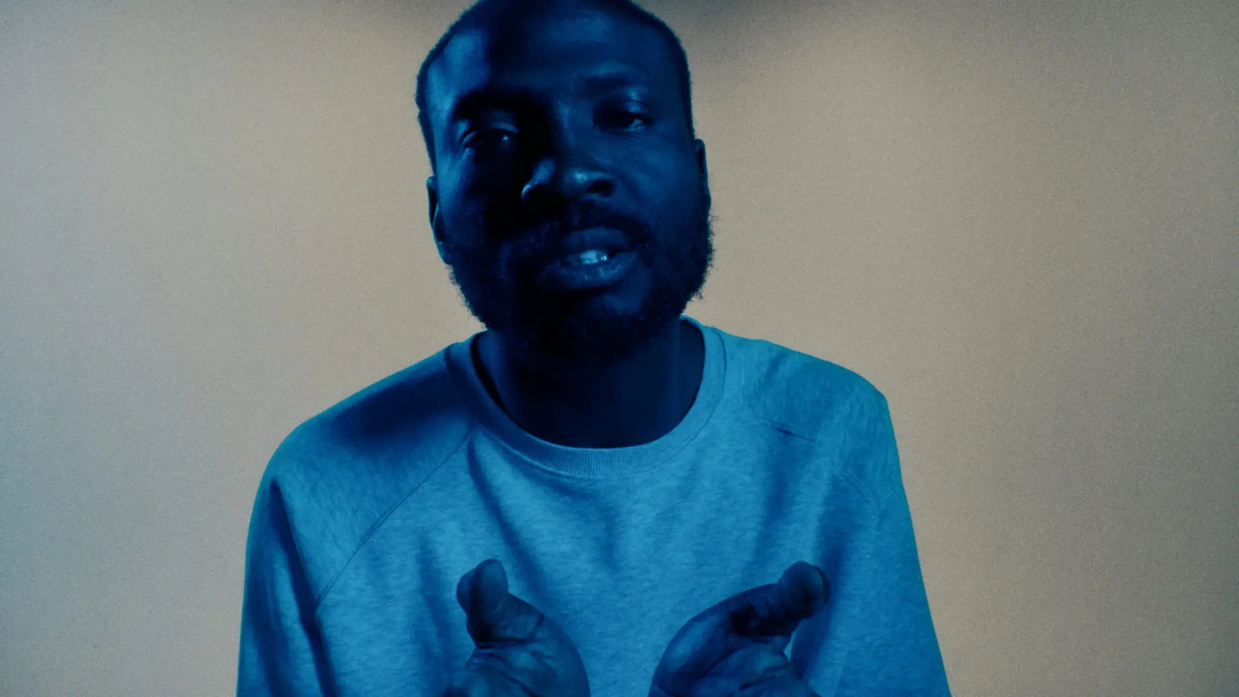 White laundry hung on a clothesline outside under a bright blue sky with some clouds, shadows of the laundry visible on the fabric.