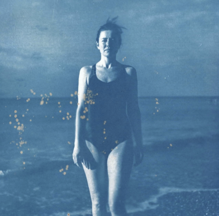 Abstract painting with a large beige area, a smaller purple square, some small patches of blue, and a gray rectangle along the bottom right edge.