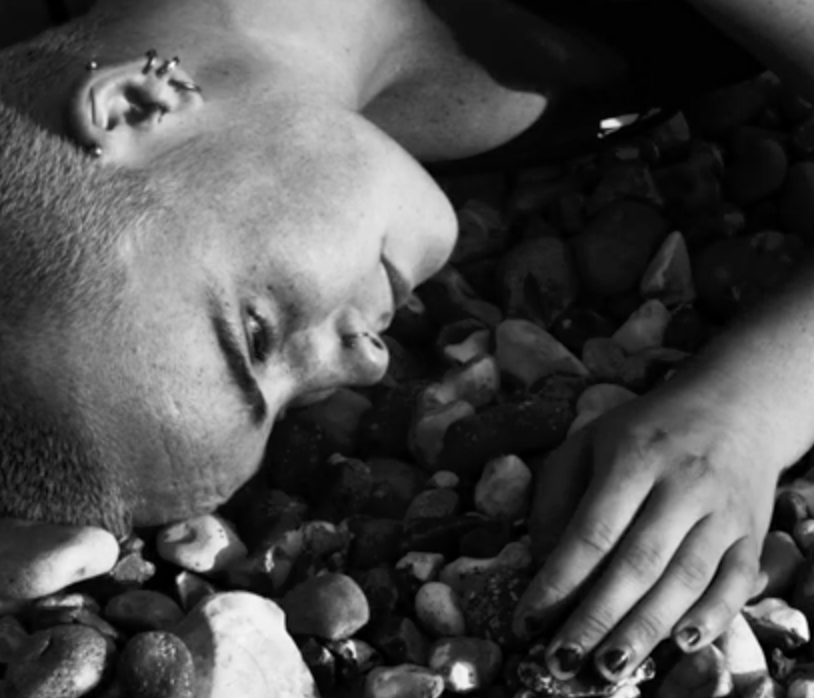 Abstract art piece featuring five large, textured circular shapes in white, black, yellow, red, and dark gray, arranged on a black and dark gray background.