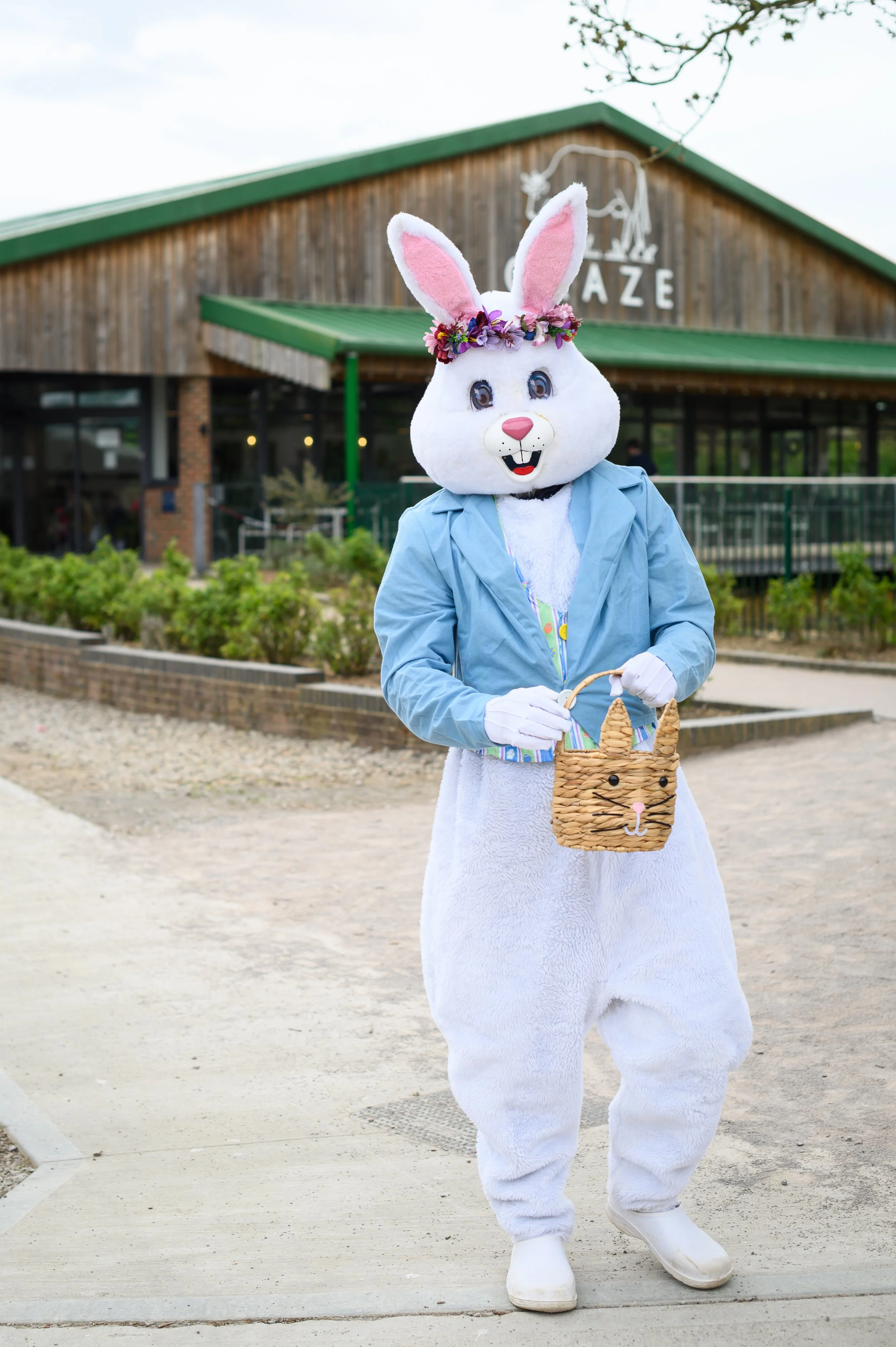 Someone in an Easter Bunny costume, waving at the camera