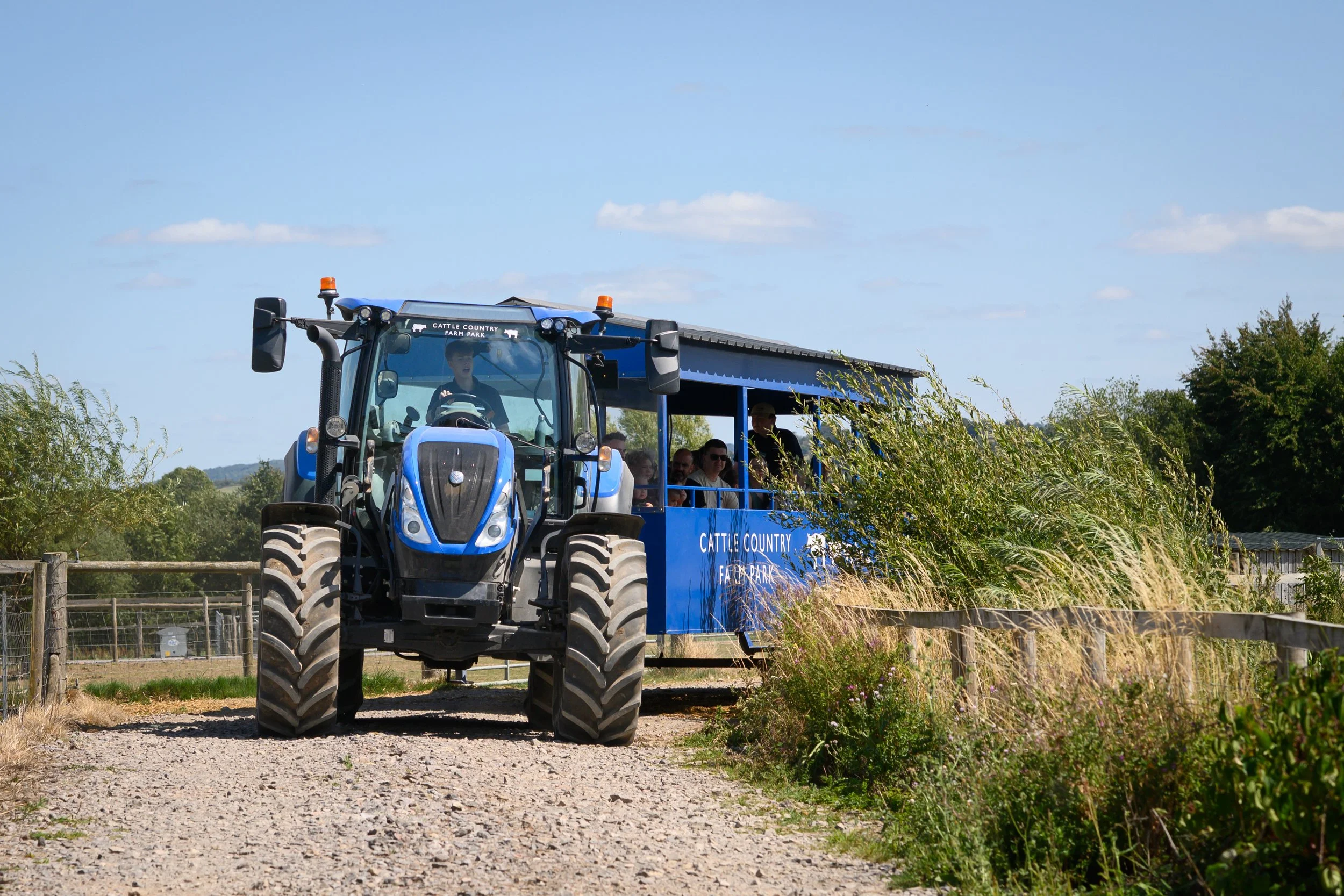 Tractor with trailer driving up a path