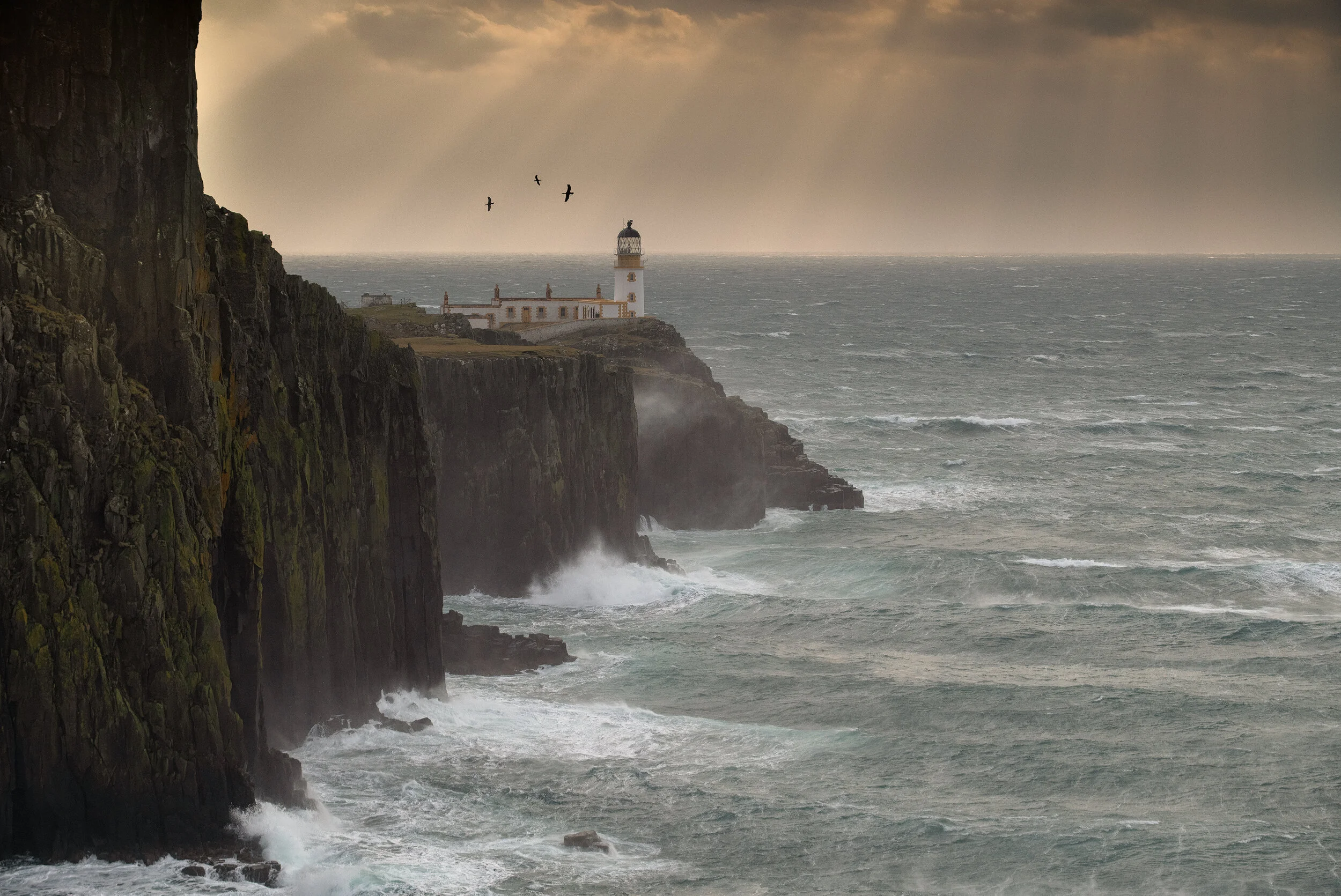 Neist Point Lighthouse, Skye.  Scotland Landscape Photography Prints.  Ocean Coastal photography print.  Featuring light beams during a Scottish storm
