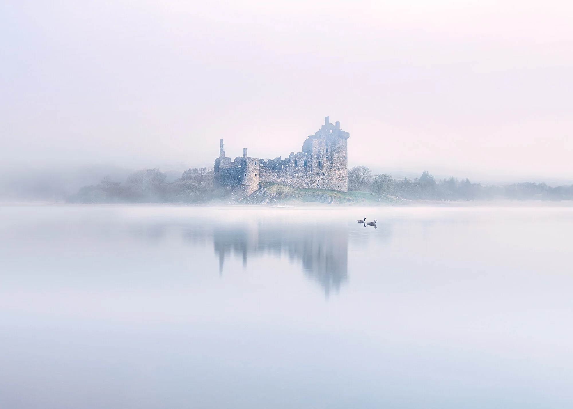 Misty landscape at Kilchurn Castle, Scotland.  A beautiful sunrise photography print in The Scottish Highlands at Loch Awe.