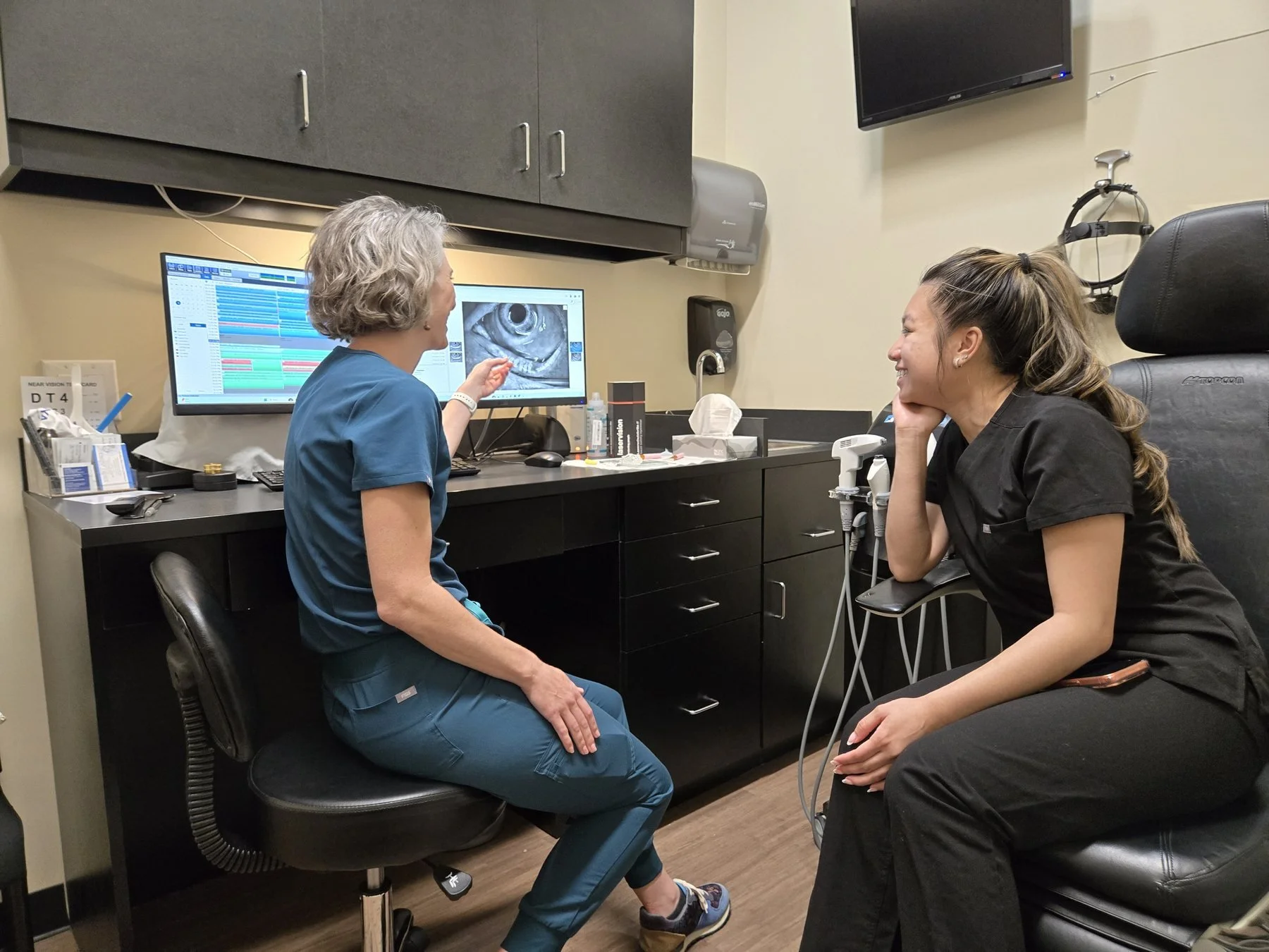 Eye doctor discussing dry eye and meibomian gland dysfunction treatment options with a patient.
