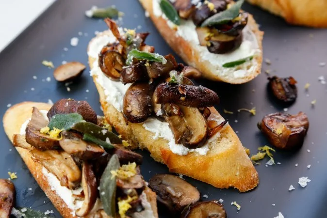 Mushroom and Crispy Sage Crostini served with a Classic Manhattan Cocktail