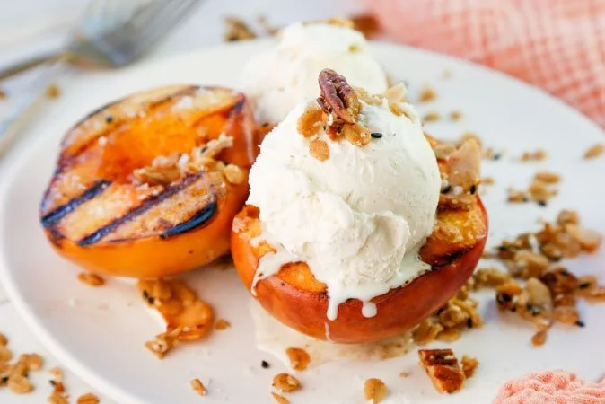 Grilled Summer Peaches with Maple Sesame Toasted Oats and Vanilla Bean Ice Cream