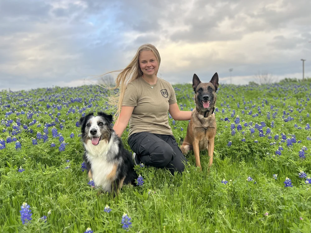 Jenna Herridge with Skipper and Varro in a field of bluebonnets
