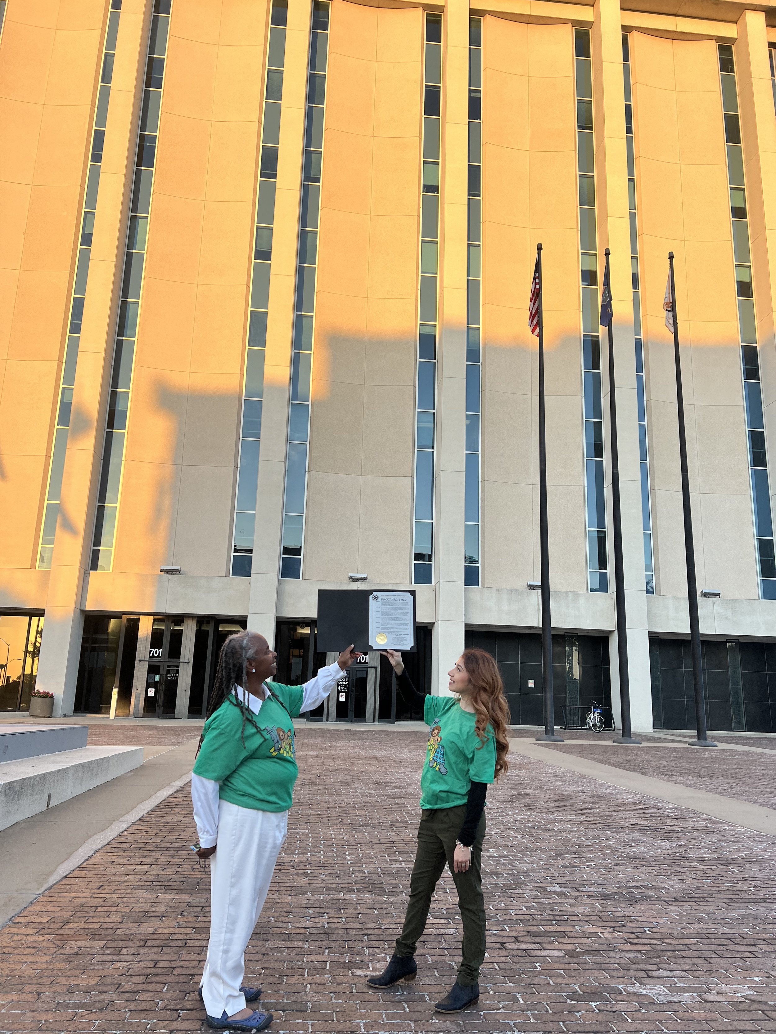 Directors Mama Jones and Berenice showing off the proclamation