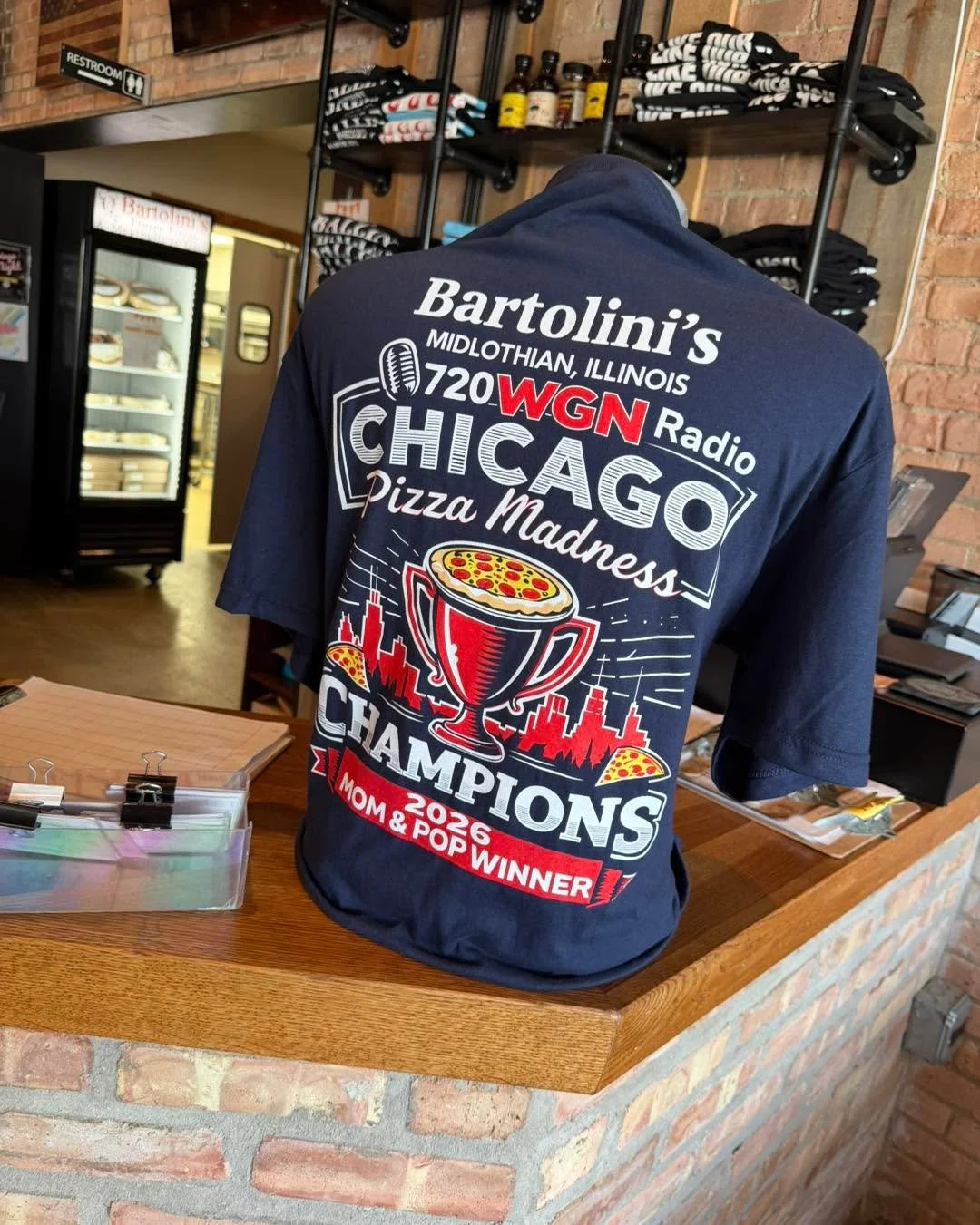 Bartolini&rsquo;s Champion 
T-Shirts Are Still Available! 

The celebration continues at Bartolini&rsquo;s, and there&rsquo;s still time to grab your WGN Pizza Madness Champion T-Shirt!

🔥 $20 each + tax
👉 Available for purchase inside the restaura