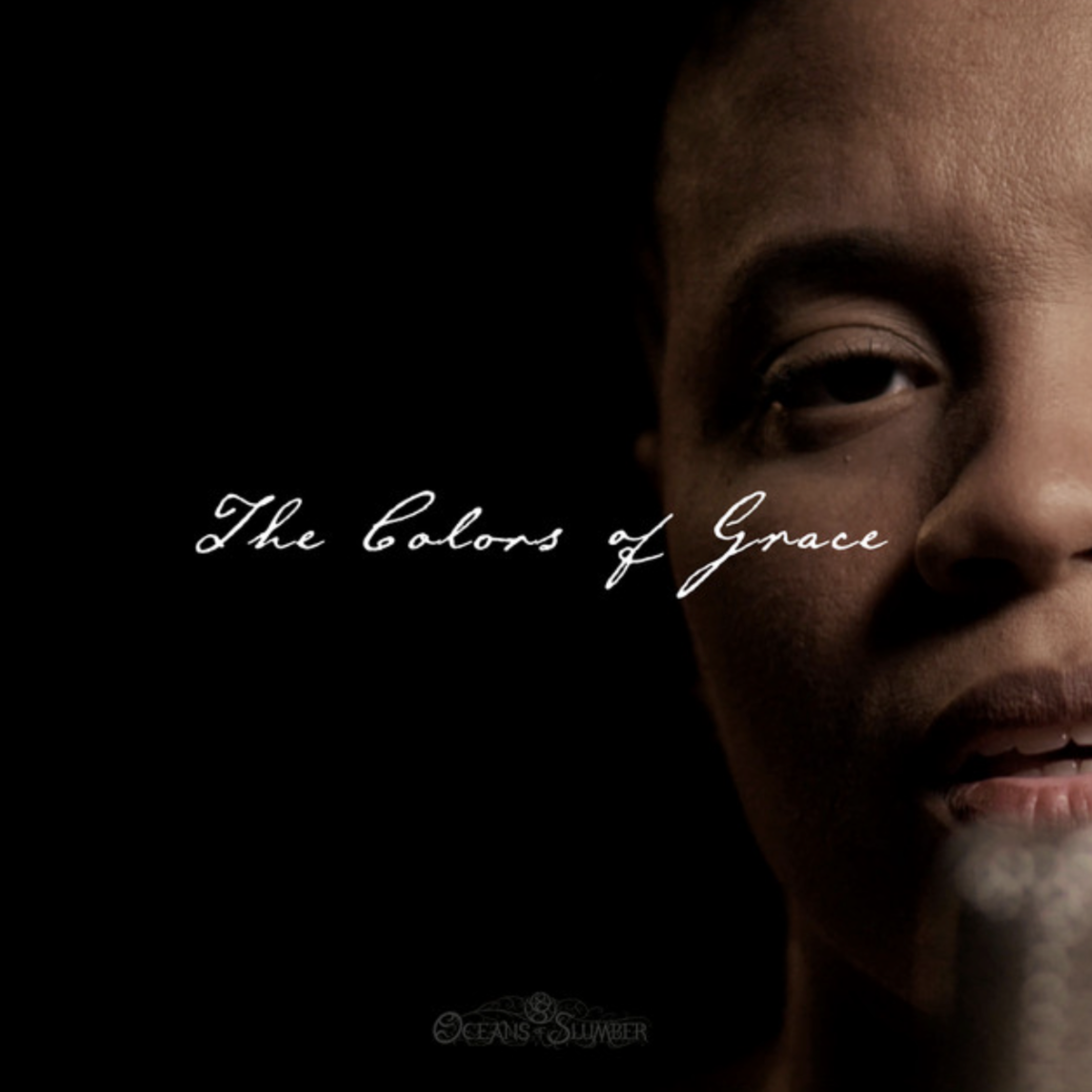 Close-up of a person's face showing part of the forehead, eye, and eyebrow against a black background with white cursive text reading 'The colors of Grace' and a decorative logo.