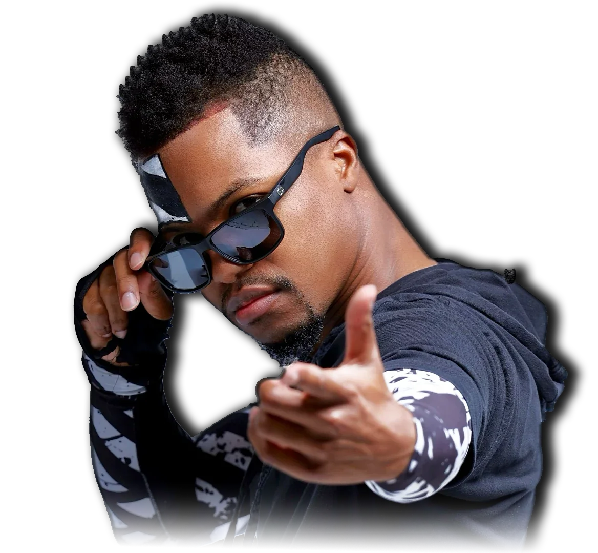 Andre Arkade wearing dark sunglasses and black clothing, pointing toward the camera