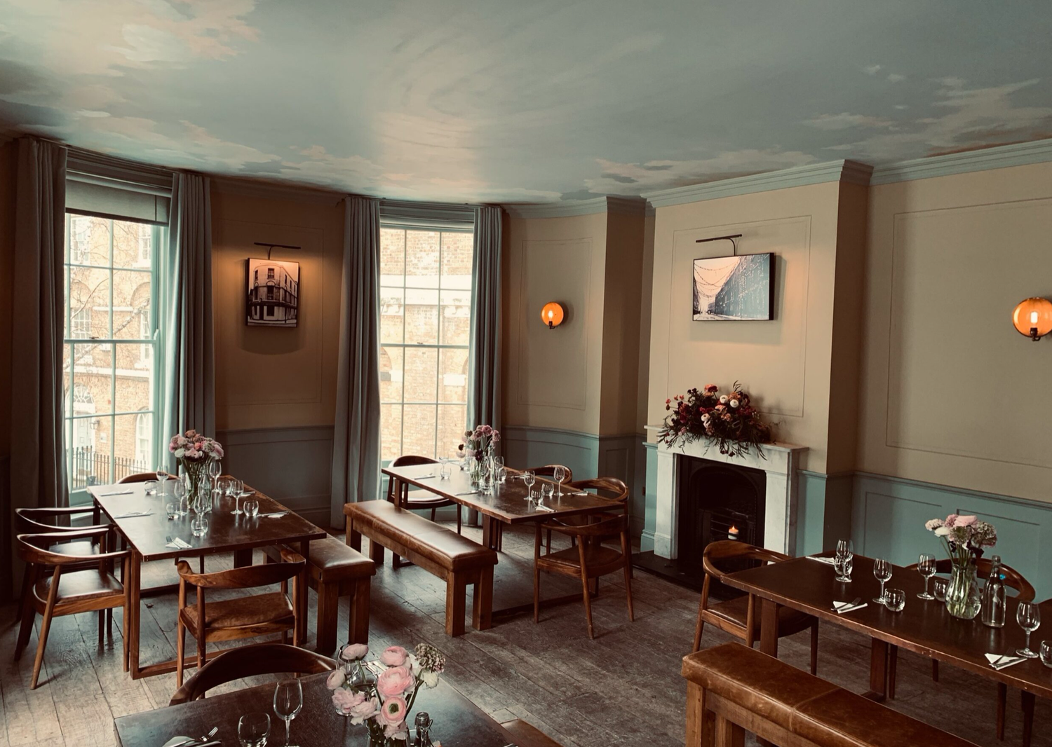The Grand Ballroom at The Sekforde, with tall sash windows, original fireplaces and long tables set for dinner