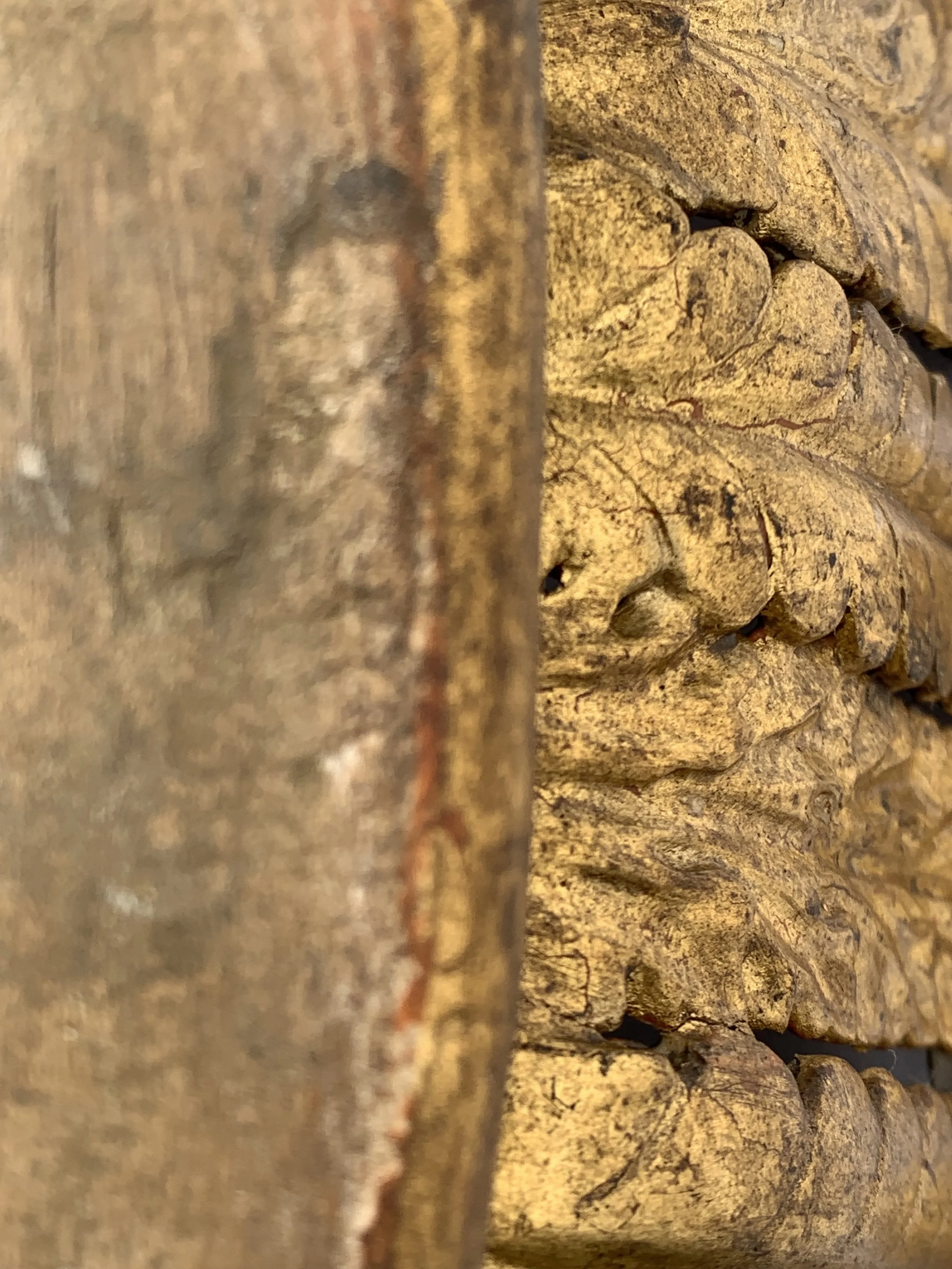Close-up of weathered wooden surface with visible grain and knots, showing a contrast between rough, uneven planks.