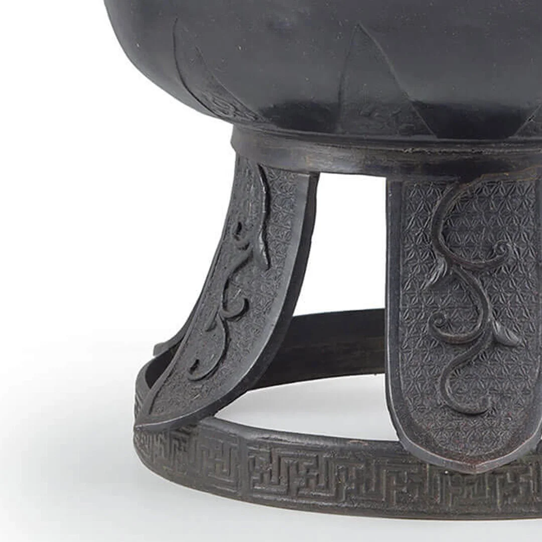 Close-up of carved dark wood furniture with intricate patterns and scrollwork.