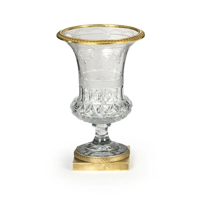 Decorative glass vase with gold accents on a white background.