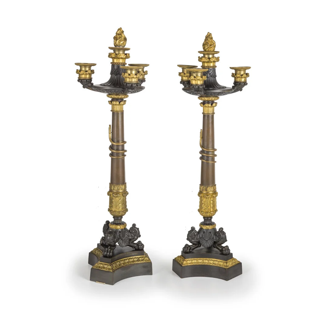 Pair of ornate candelabras with black and gold detailing on a white background.