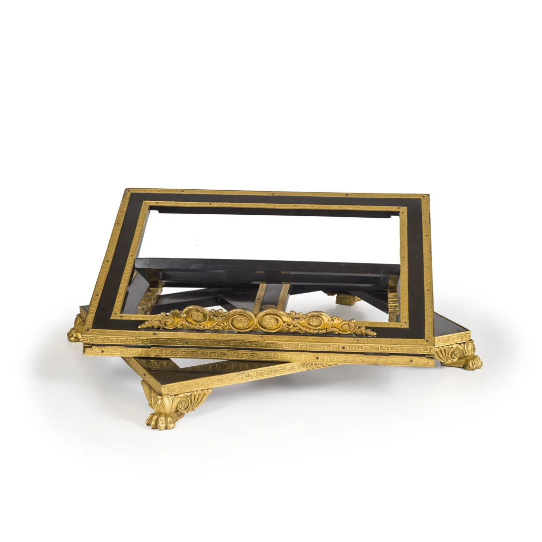 Decorative picture frame with gold accents and lion paw feet, placed on a white background.