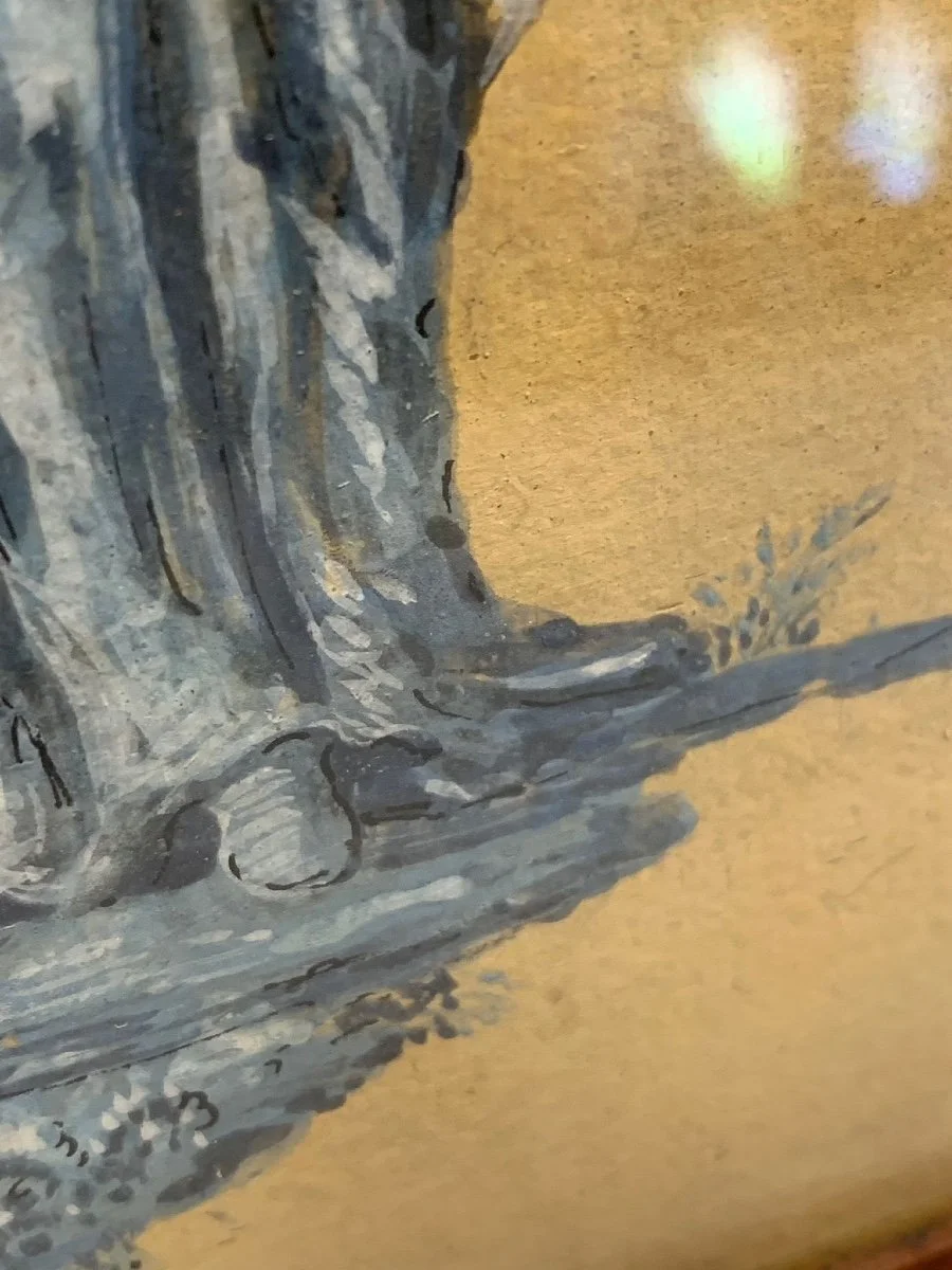 Close-up of a painted tree trunk and branch on a textured yellow wall background.