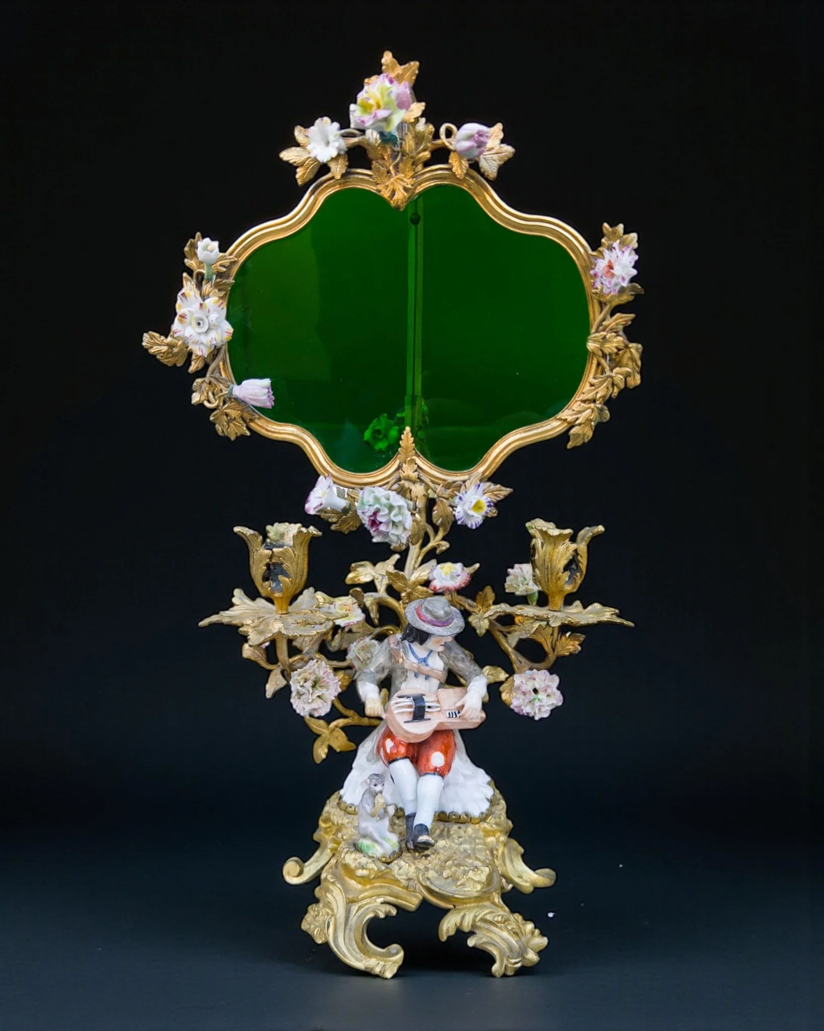 Two-light candelabrum with a porcelain statuette of a man playing an instrument