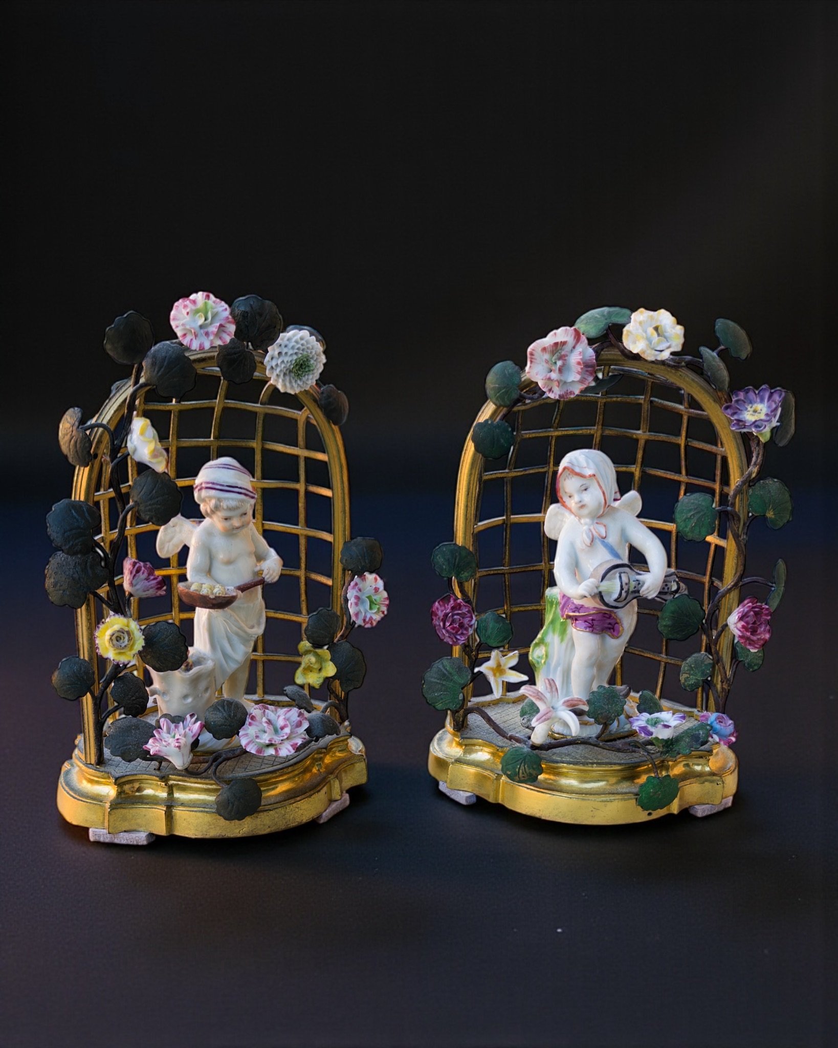 A pair of statuettes of two young angels polychrome European porcelain