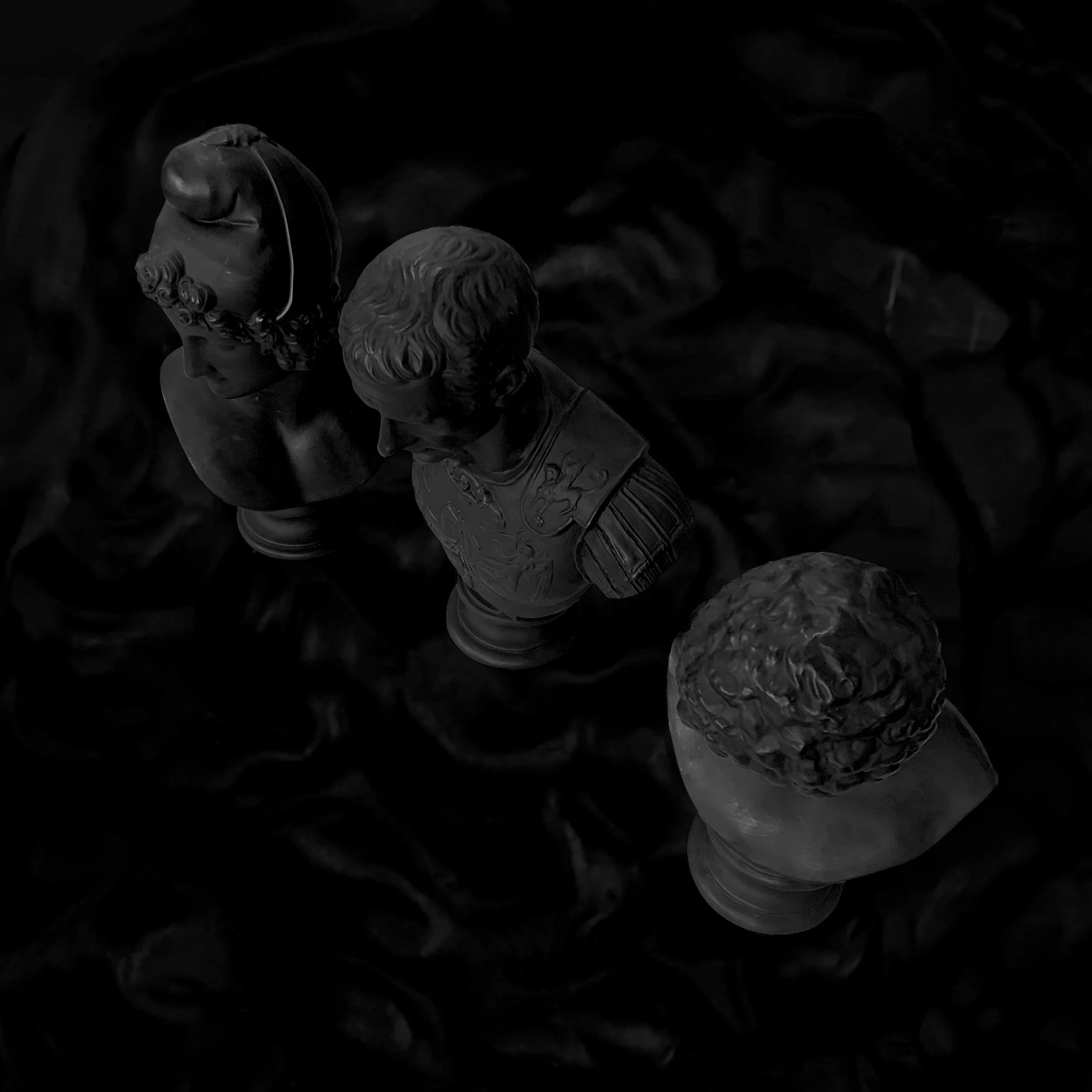 Three chess pawn statues arranged in a row on a chessboard, with varying head and shoulder details.