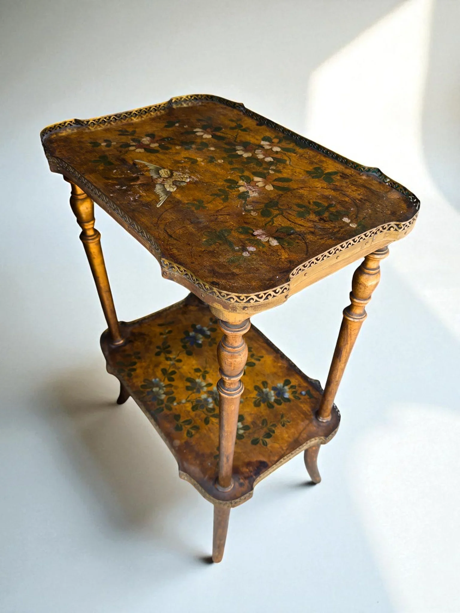 SOLD: A small two-story etagere with gilded metal border