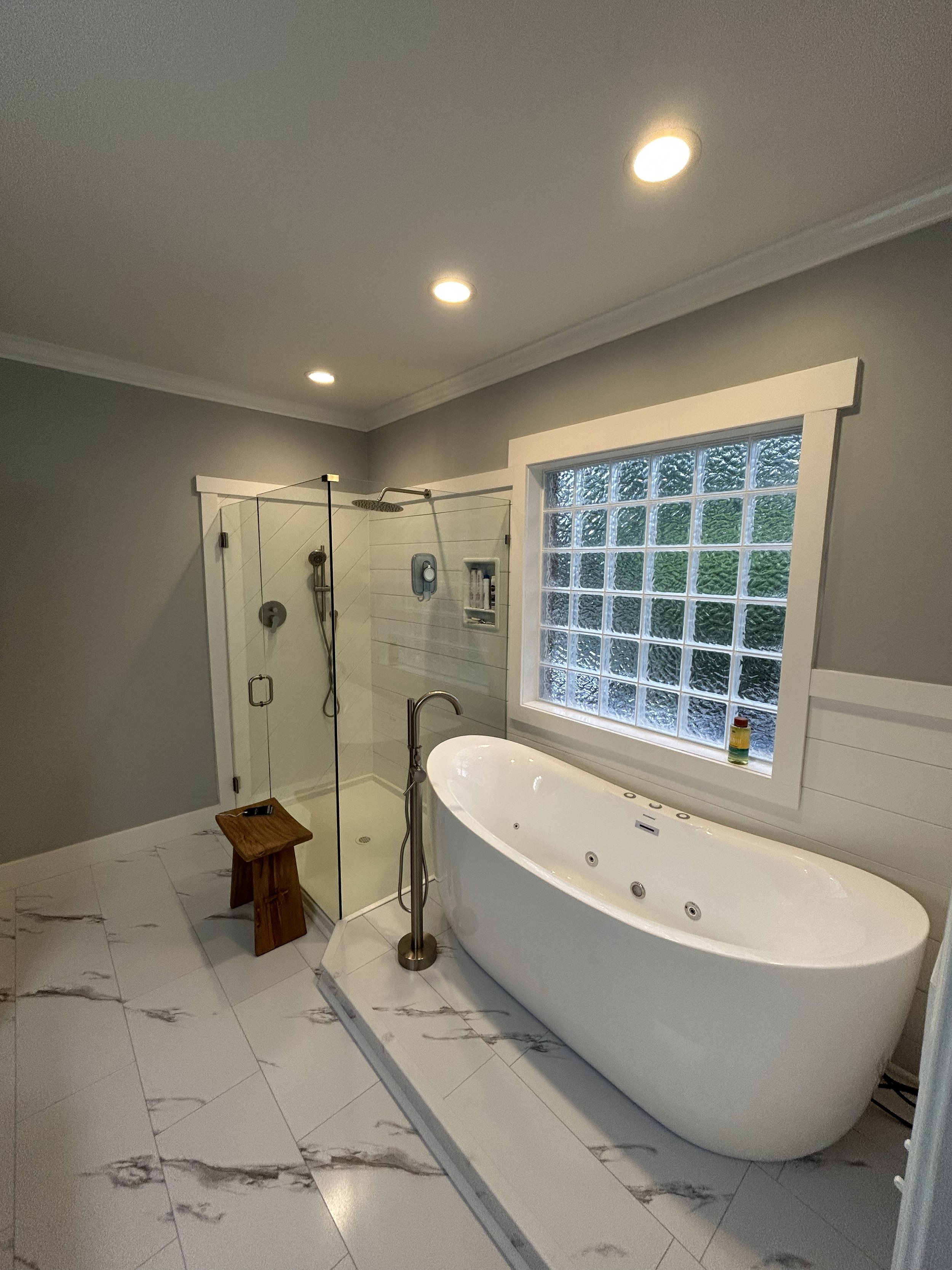 A stand-alone jetted bathtub