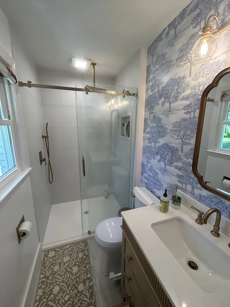 A sliding door was a must in this narrow bathroom. But a modern frameless slider is very handsome.