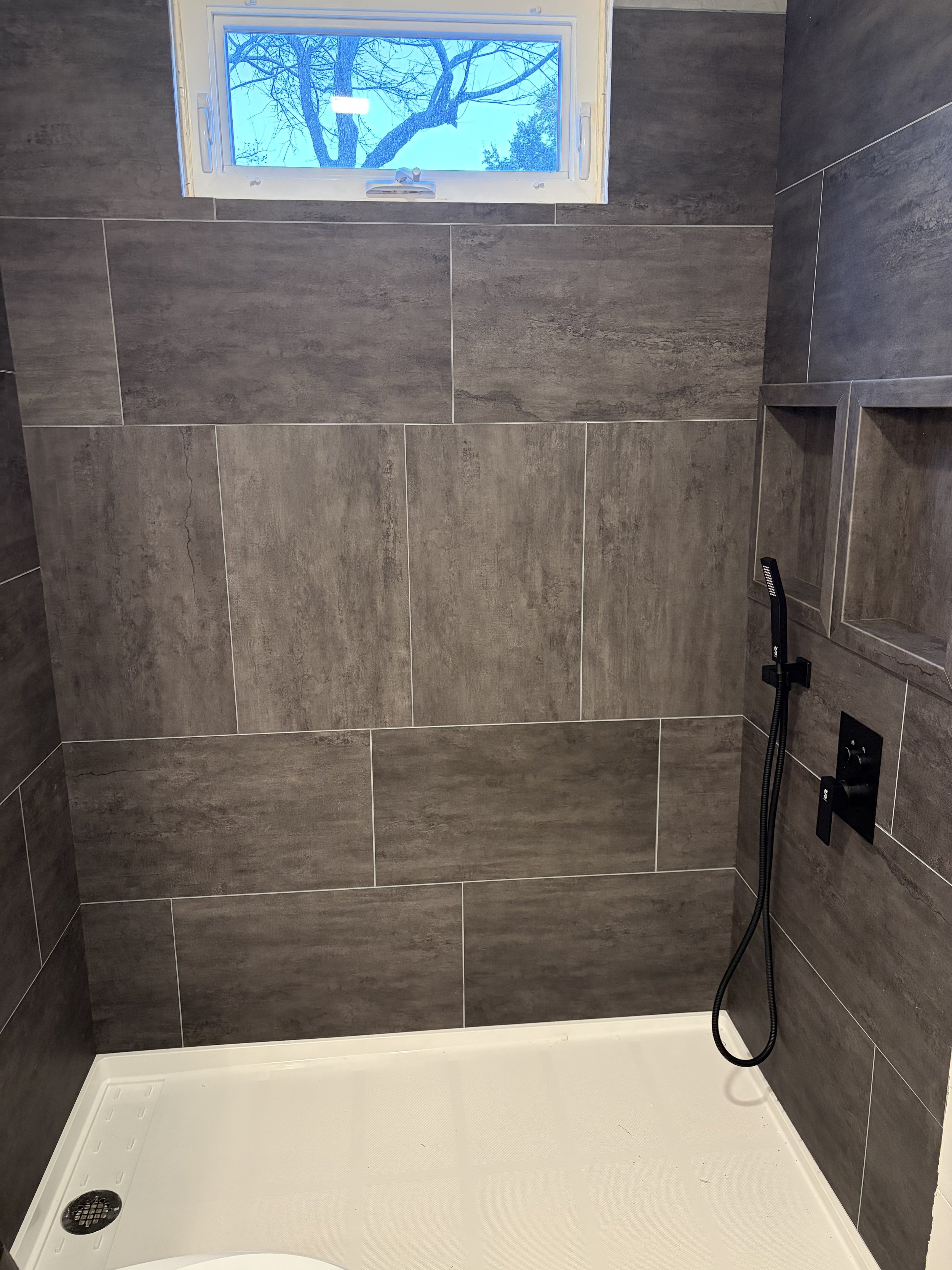 Vinyl wall tiles can be installed horizontally, vertically or both directions. This tile is called Cracked Slate. 