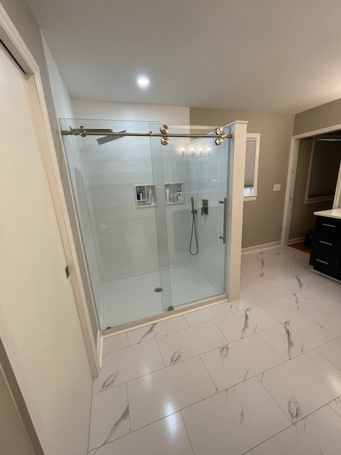 A small bedroom, a tiny bathroom, and two closets were transformed to yield a huge bathroom and gigantic walk-in closet