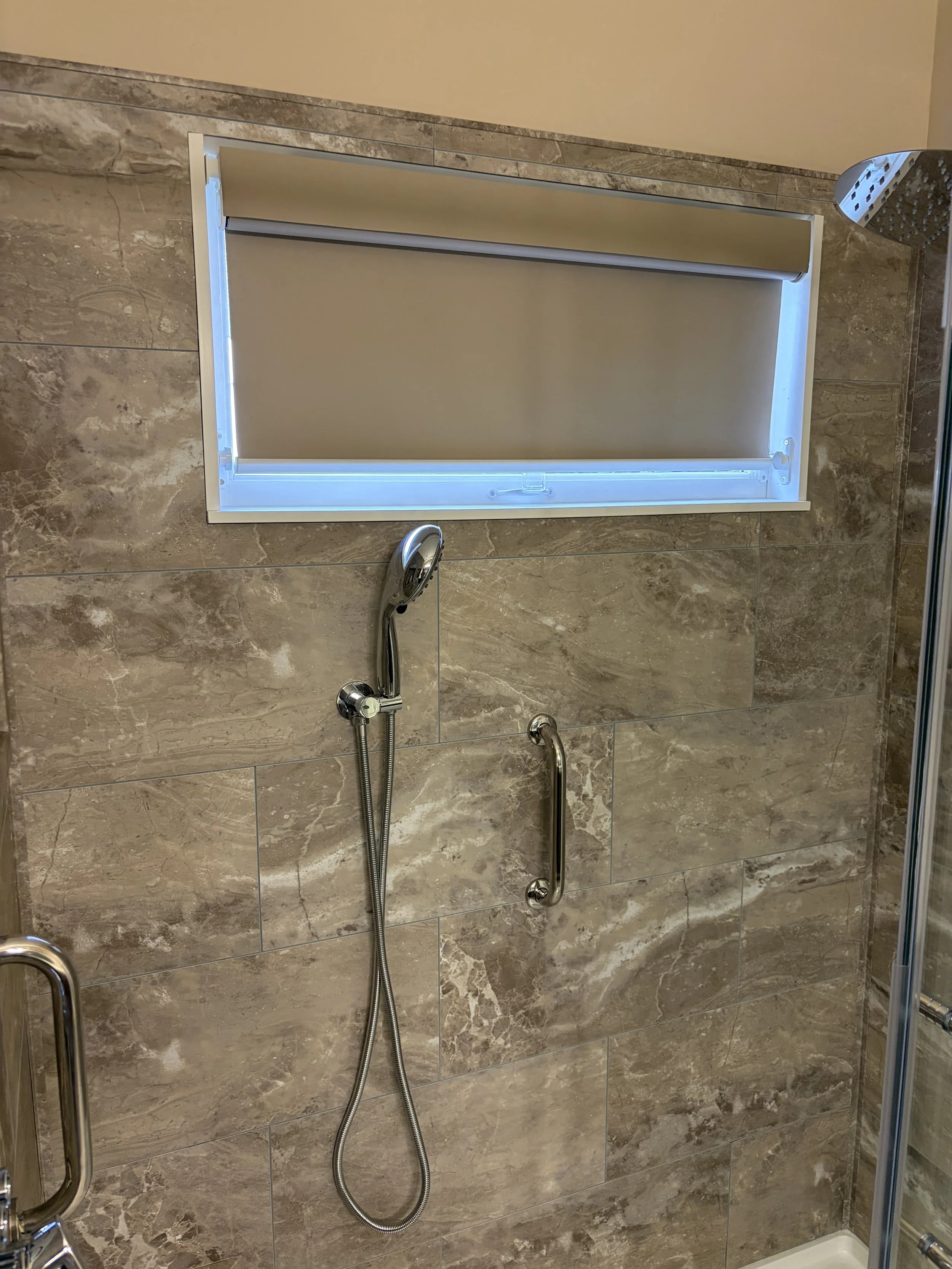 Our client wanted to cover the window when showering at night so we added a water-proof blind.